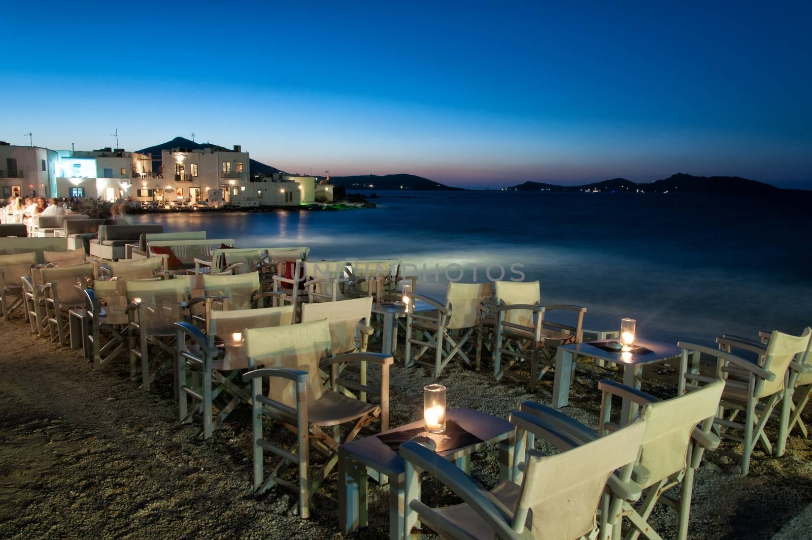 Cozy restaurant at night in Naussa, Paros by mitakag