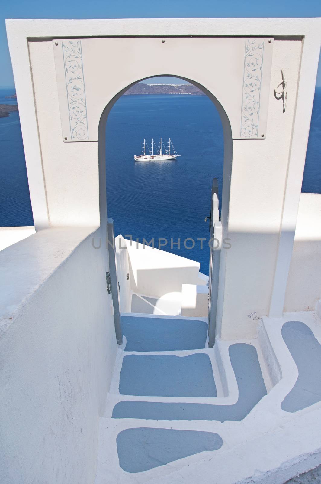 Narrow staircase with arch and seaview in Oia, Santorini, Greece