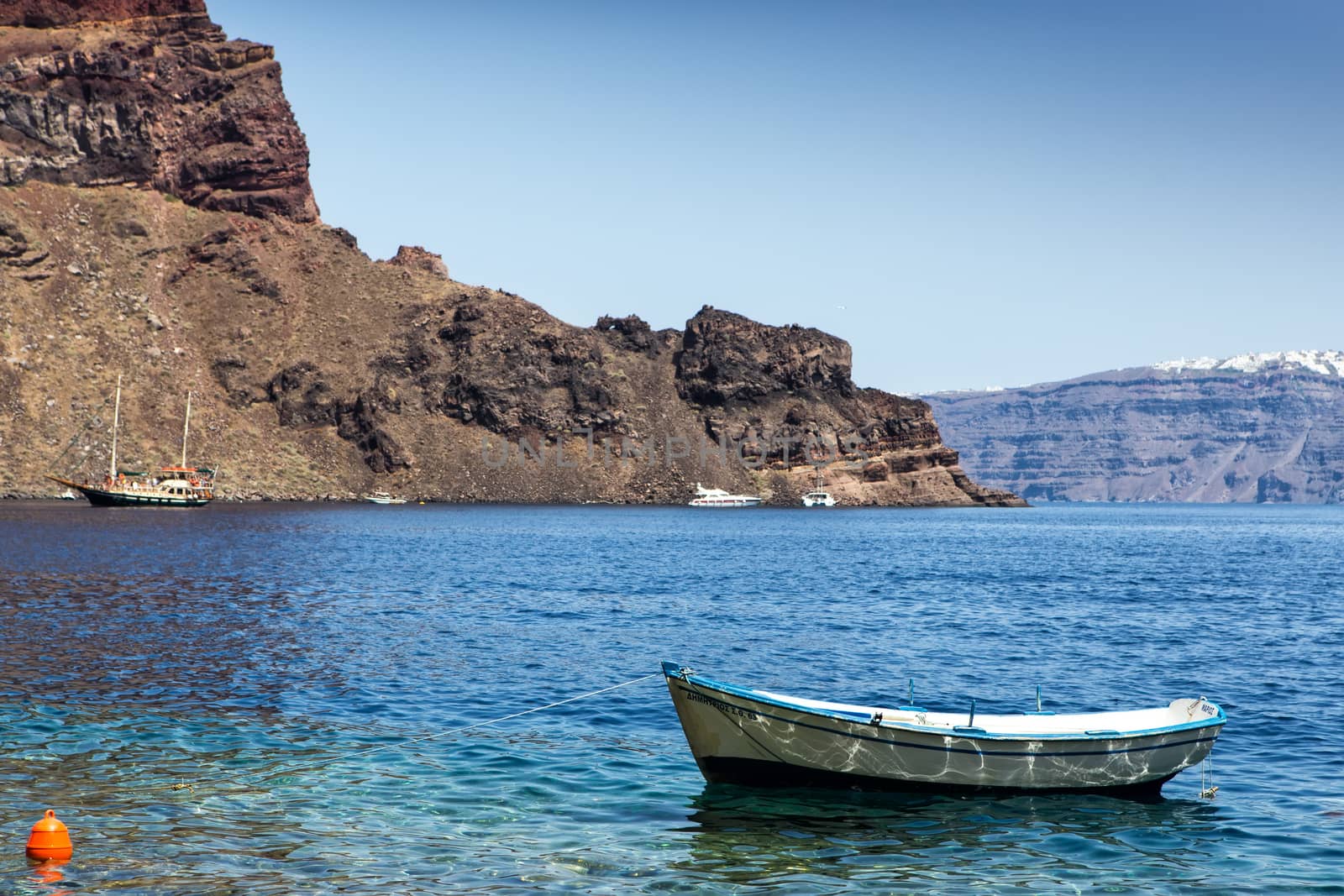 Lonely fishing boat at coastline of Aegean sea, Greece