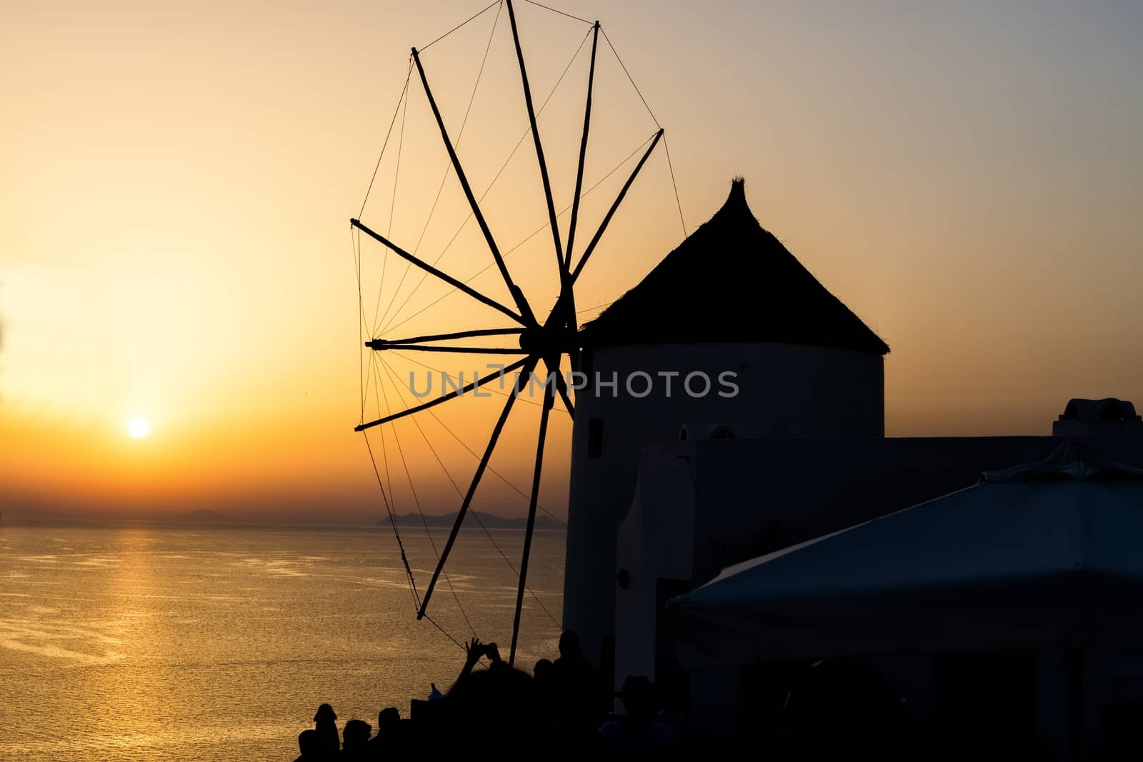 Windmill in Oia, Santorini. Oia is a village in the north west edge of the Santorini island with white houses, narrow streets and amazing seaviews.