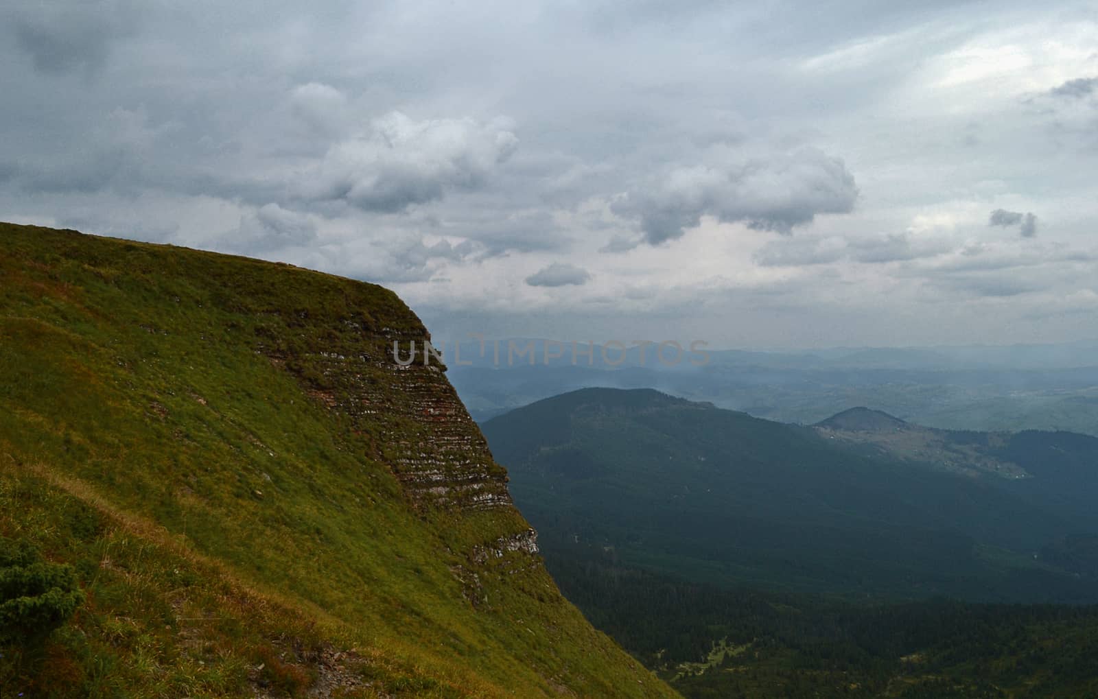 Mountain peaks in the autumn evening sky with clouds by Irene1601