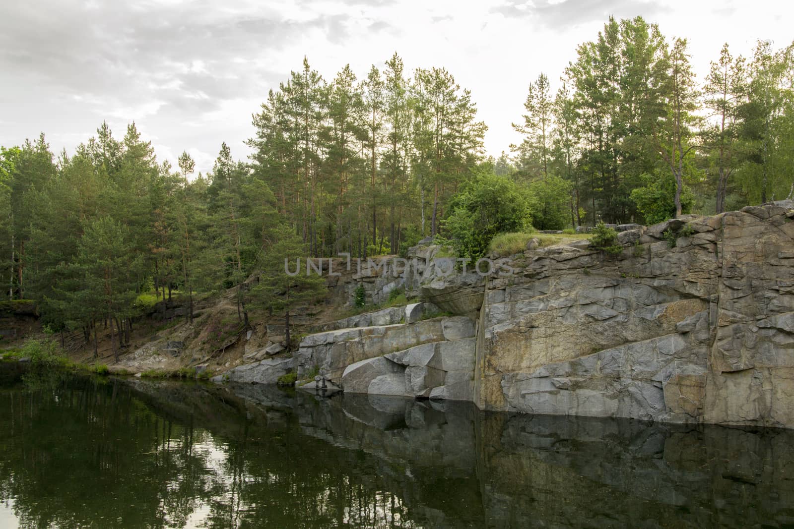 Lake in the stone canyon surrounded by forest by Irene1601