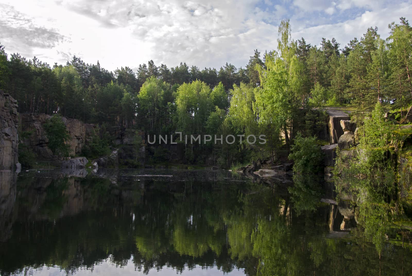 Lake in the stone canyon surrounded by forest by Irene1601