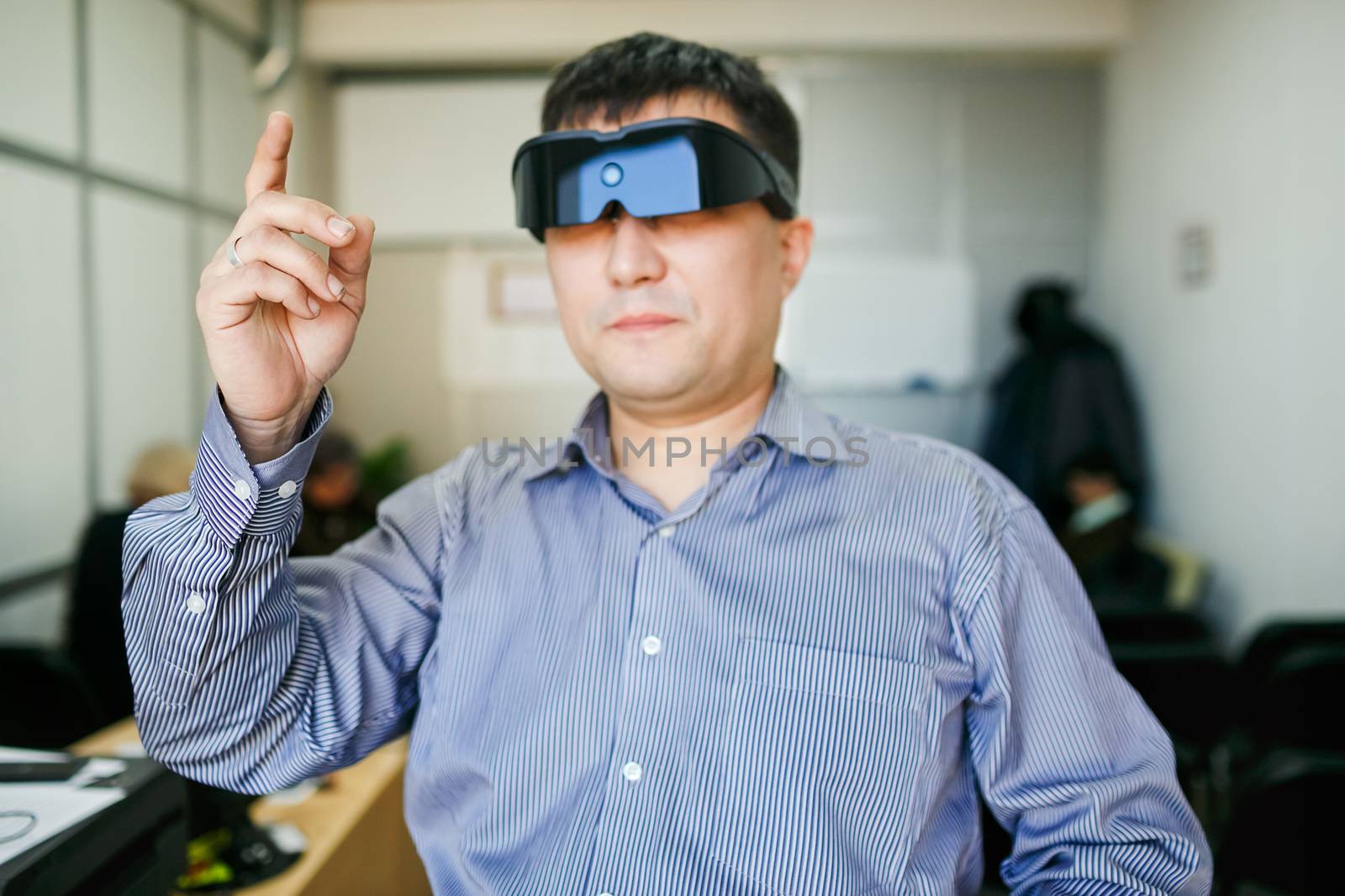 A man in 3d computer glasses touching the air