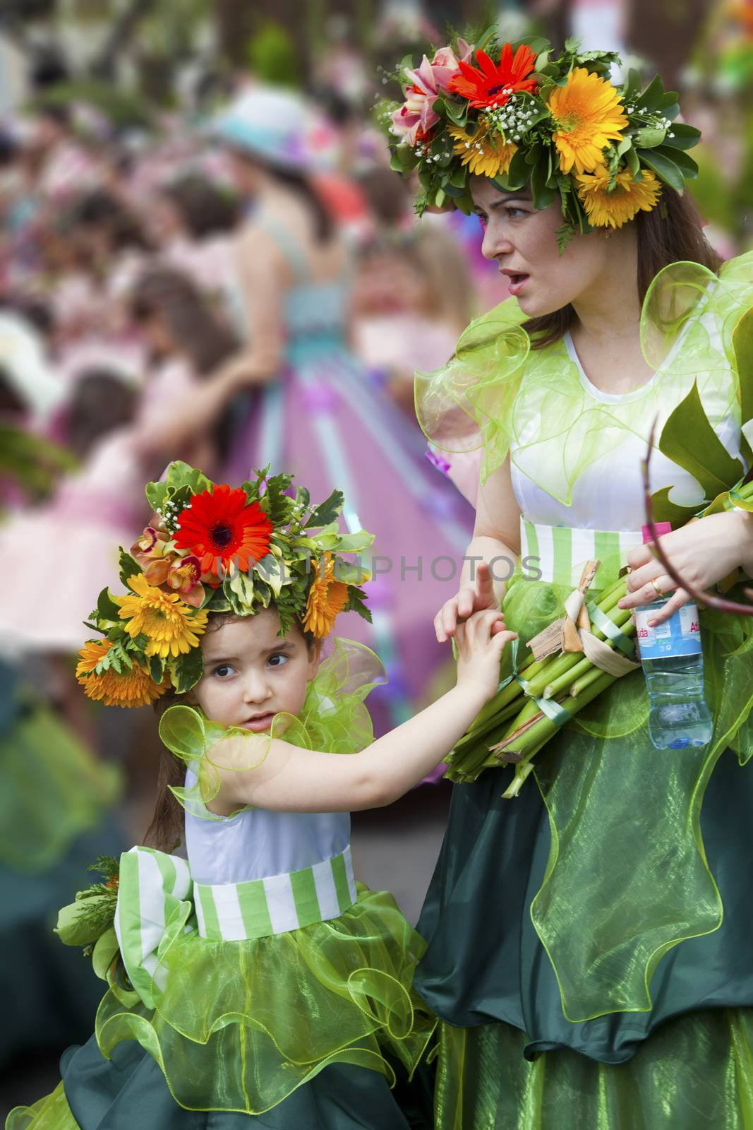 Performers with colorful and elaborate costumes taking part in the Parade of Flower Festival on the Madeira Island, Portugal.