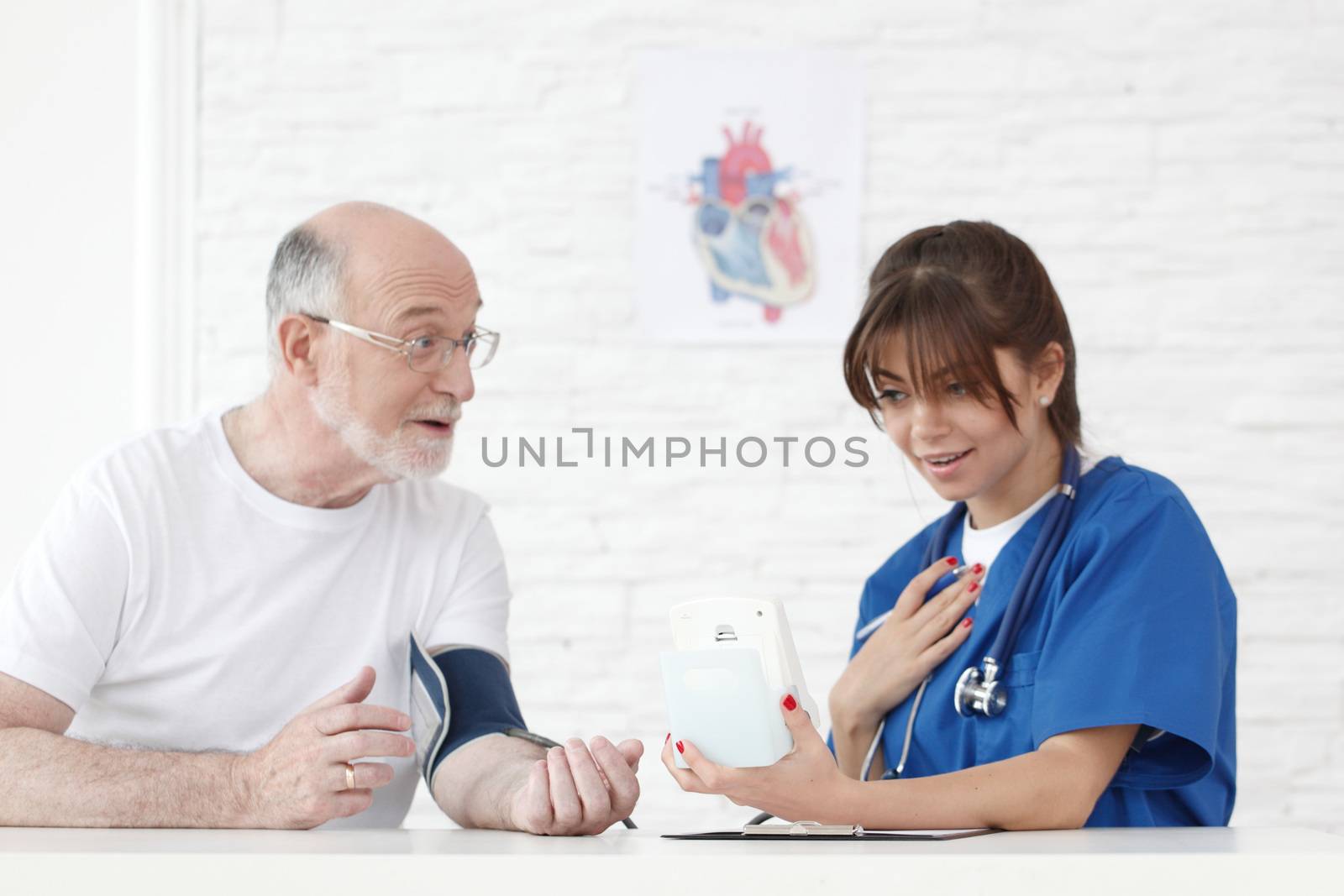 Doctor measuring blood pressure of male senior patient