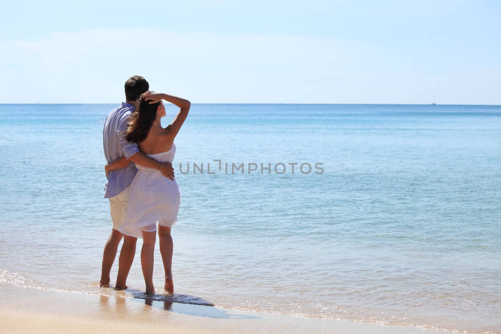 Couple walking on beach by ALotOfPeople