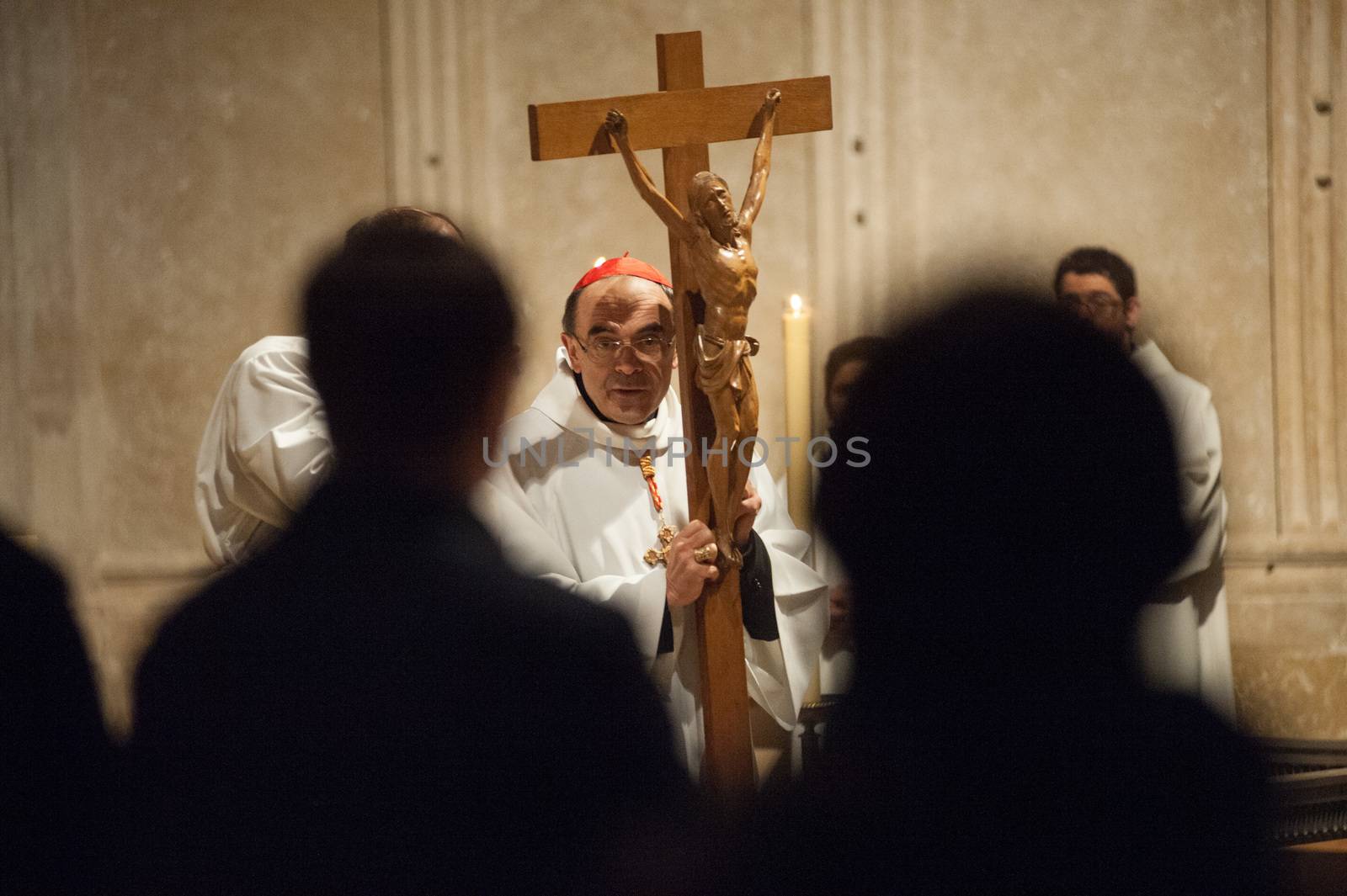 FRANCE, Lyon: Roman Catholic Cardinal, Archbishop of Lyon, Philippe Barbarin takes part in a Good Friday mass on March 25, 2016 in Saint-Jean cathedral in Lyon, central eastern France. Barbarin, accused of covering up the sexual abuse of children by priests apologised to victims during a mass on March 23, according to the website of his diocese. Barbarin, quoting Pope Francis, said on March 23 he was obliged to assume all the evil committed by some priests and personally apologise for the damage they have caused by sexually abusing children.