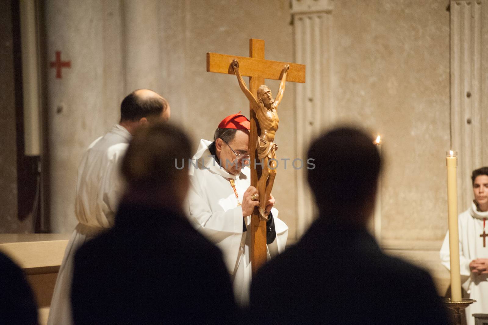 FRANCE, Lyon: Roman Catholic Cardinal, Archbishop of Lyon, Philippe Barbarin takes part in a Good Friday mass on March 25, 2016 in Saint-Jean cathedral in Lyon, central eastern France. Barbarin, accused of covering up the sexual abuse of children by priests apologised to victims during a mass on March 23, according to the website of his diocese. Barbarin, quoting Pope Francis, said on March 23 he was obliged to assume all the evil committed by some priests and personally apologise for the damage they have caused by sexually abusing children.
