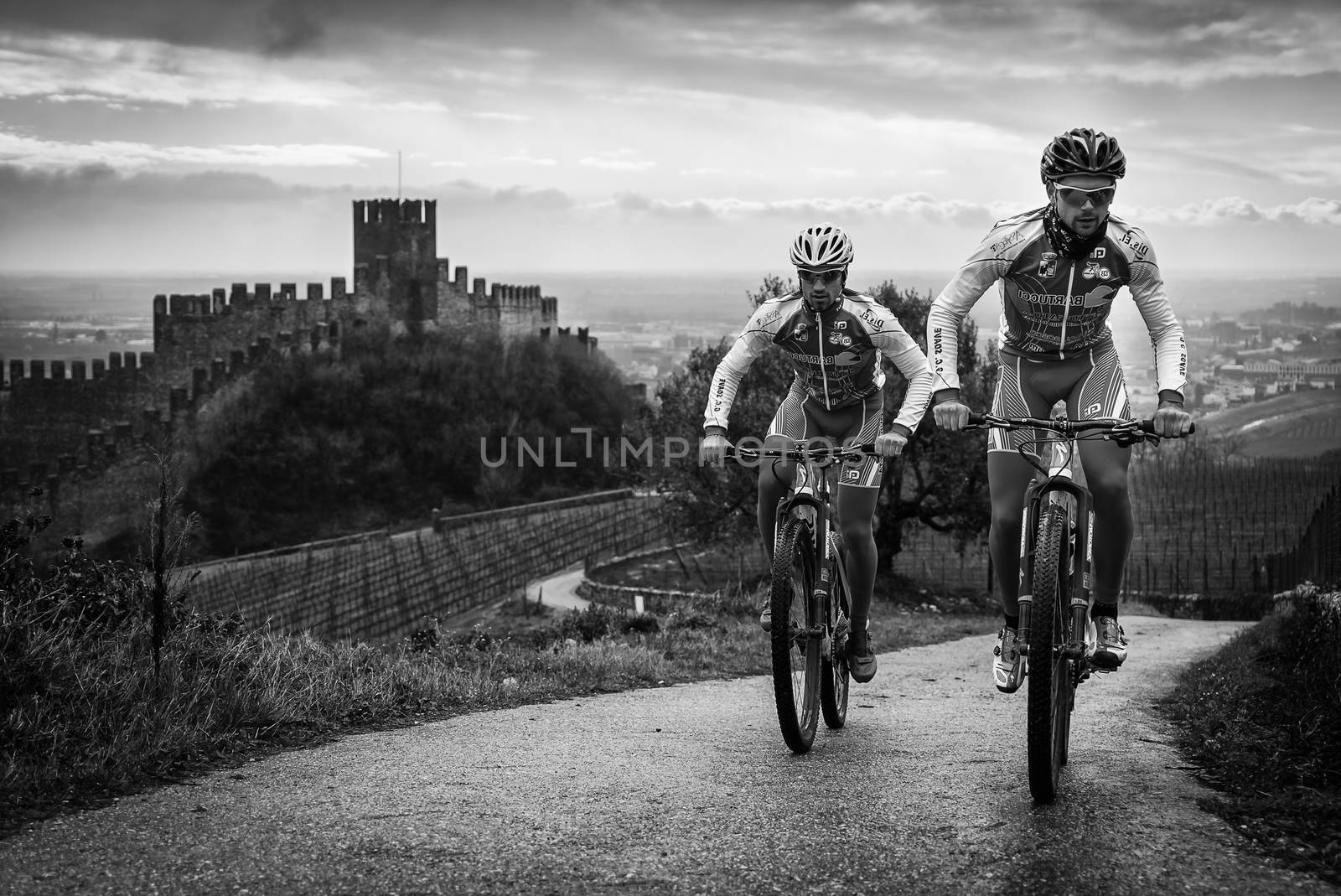 Cyclists train on the hills surrounding the castle of Soave. by Isaac74