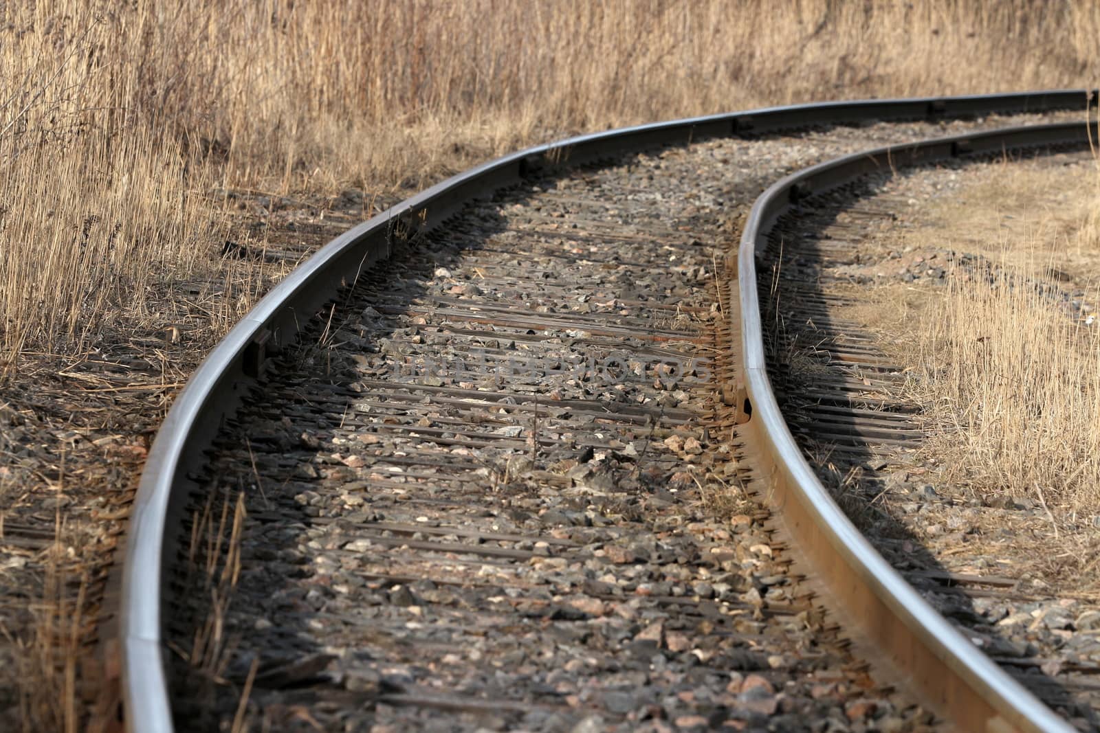 railway turns  through autumn field