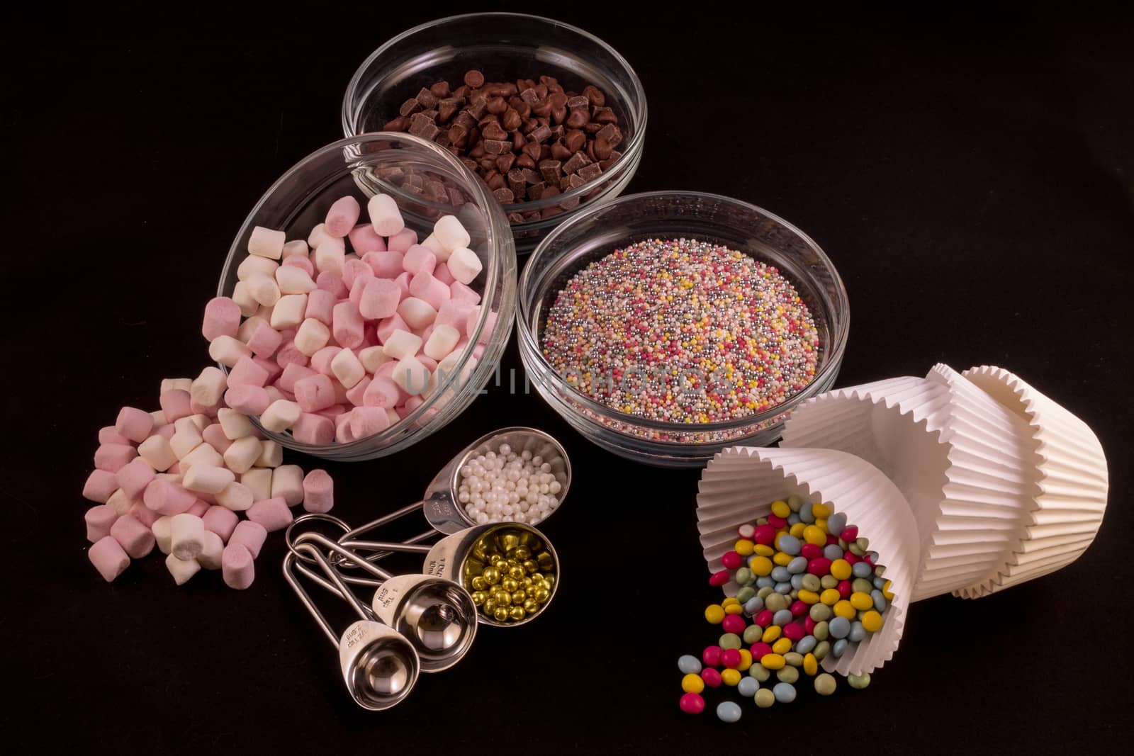 Different cake decorations laid out against a black background