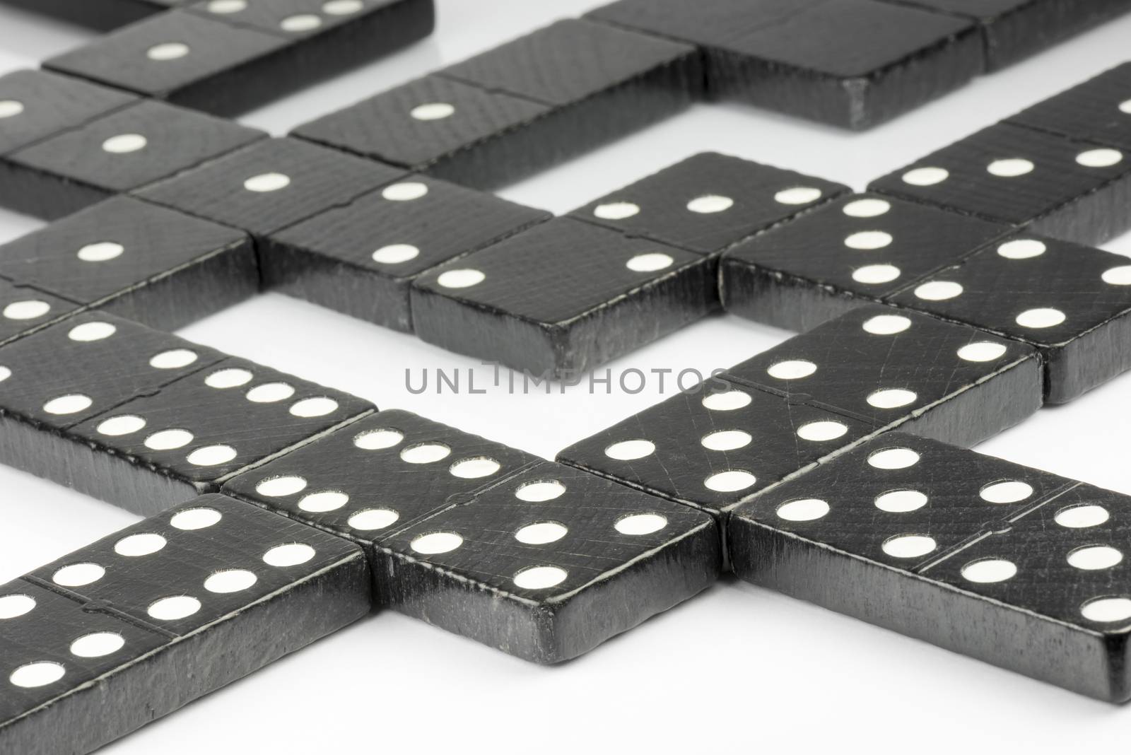 Composition of lying black domino bricks with white dots
