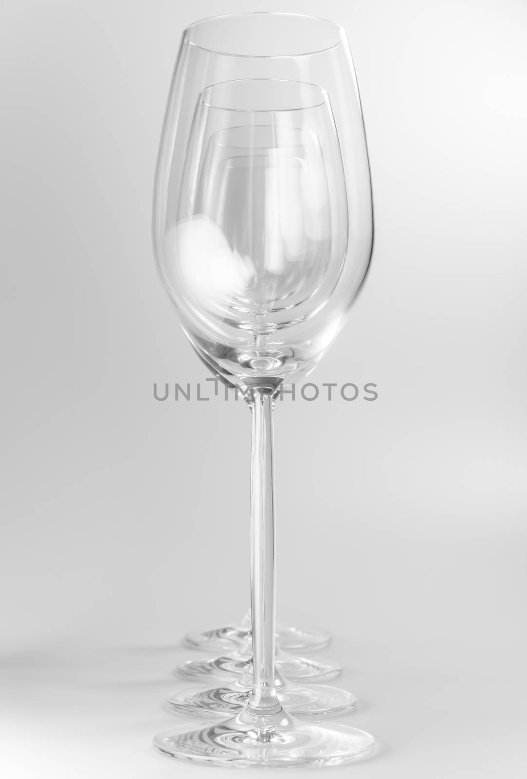 Four crystal wine glasses in a row
 by Tofotografie