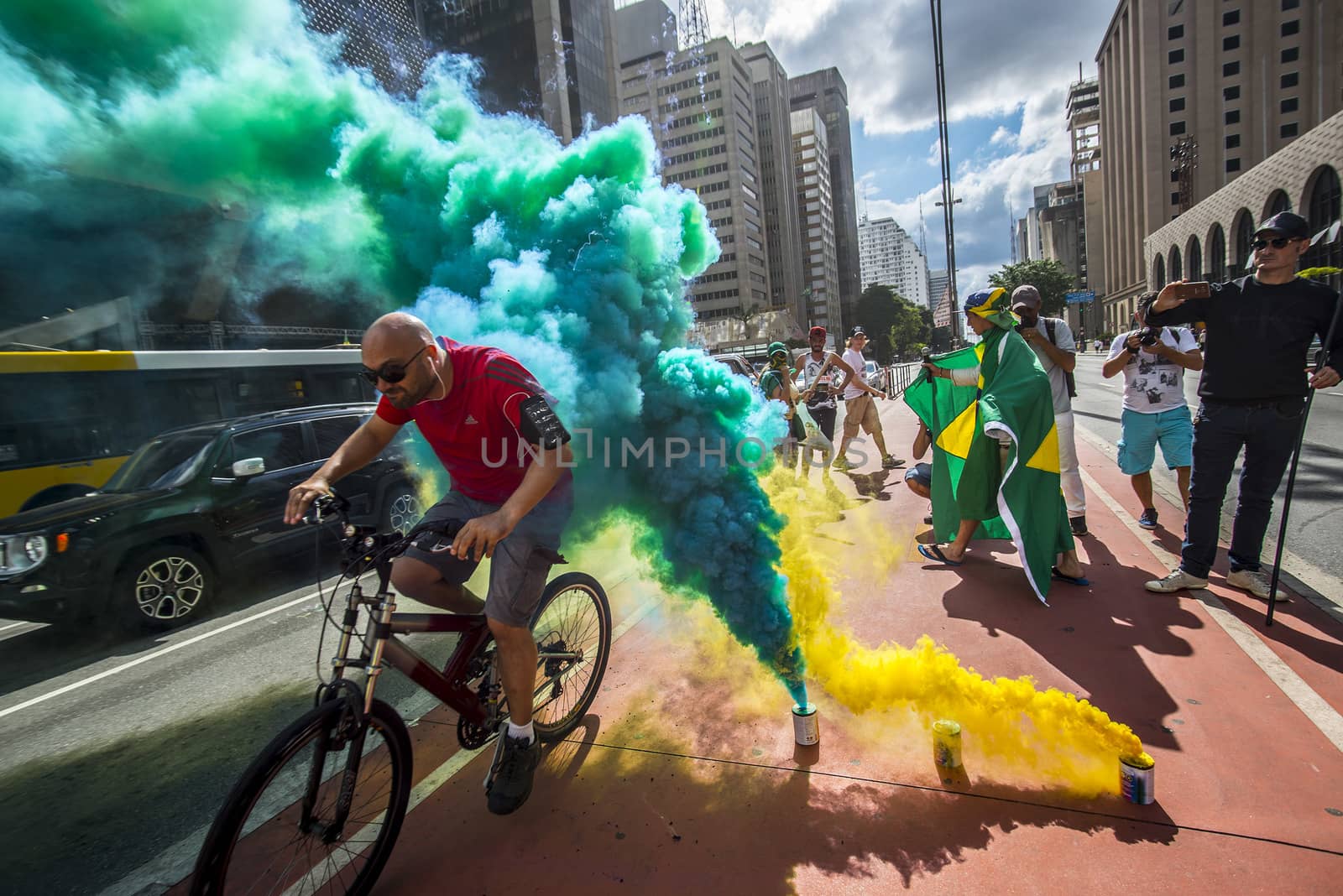 BRAZIL, Sao Paulo: Smoke grenades release green, bleu and yellow fumes, the colors of the national flag, during a protest for the impeachment of President Dilma Rousseff, against former president Lula and against corruption in Petrobras scandal case in Sao Paulo, Brazil on March 26, 2016. Brazilian lawmakers relaunched impeachment proceedings against President Dilma Rousseff Thursday and a judge blocked her bid to bring her powerful predecessor into her cabinet, intensifying the political crisis engulfing her. 