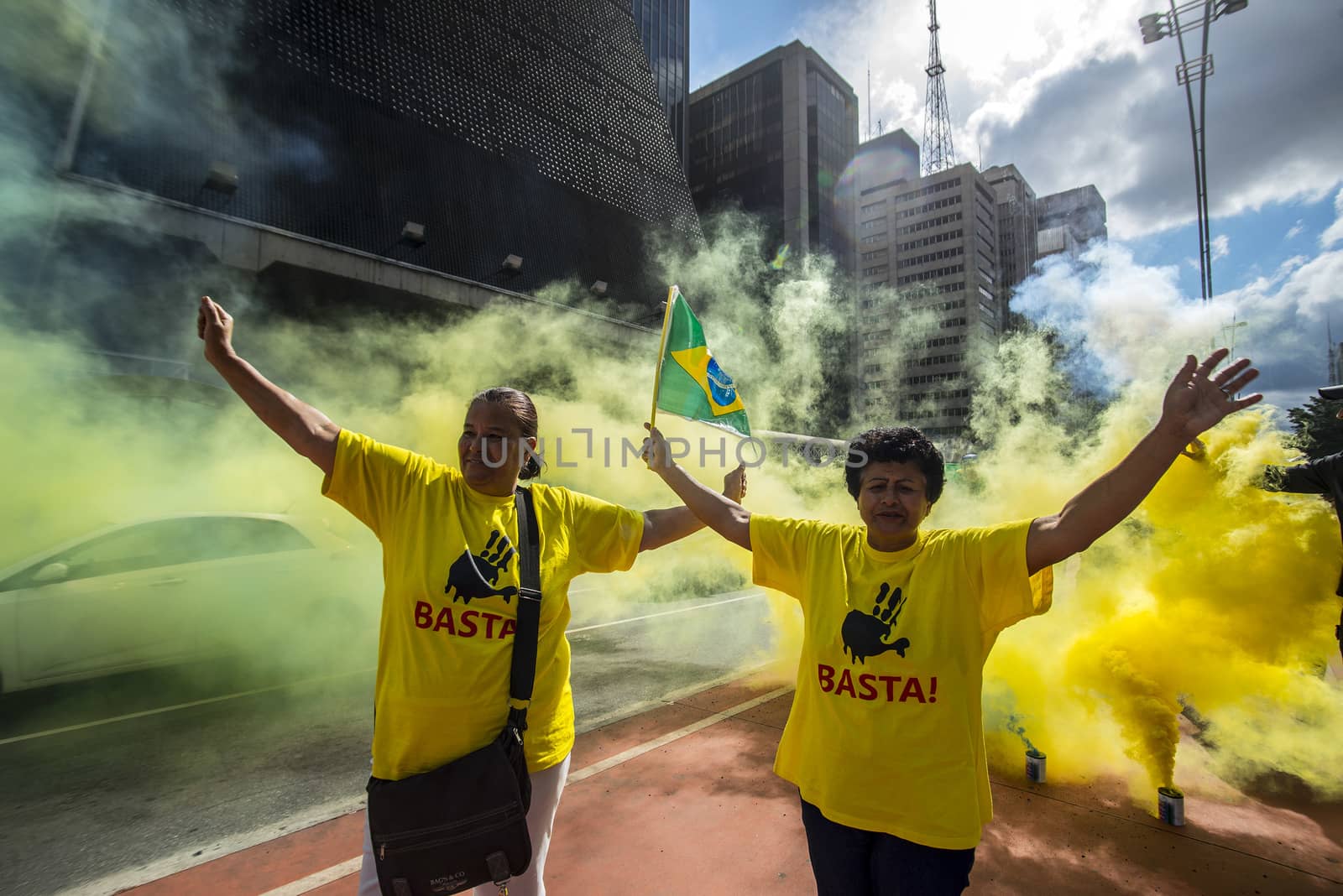 BRAZIL, Sao Paulo: Two demonstrators raise their hands and wear a t-shirt reading Basta! during a protest for the impeachment of President Dilma Rousseff, against former president Lula and against corruption in Petrobras scandal case in Sao Paulo, Brazil on March 26, 2016. Brazilian lawmakers relaunched impeachment proceedings against President Dilma Rousseff Thursday and a judge blocked her bid to bring her powerful predecessor into her cabinet, intensifying the political crisis engulfing her. 
