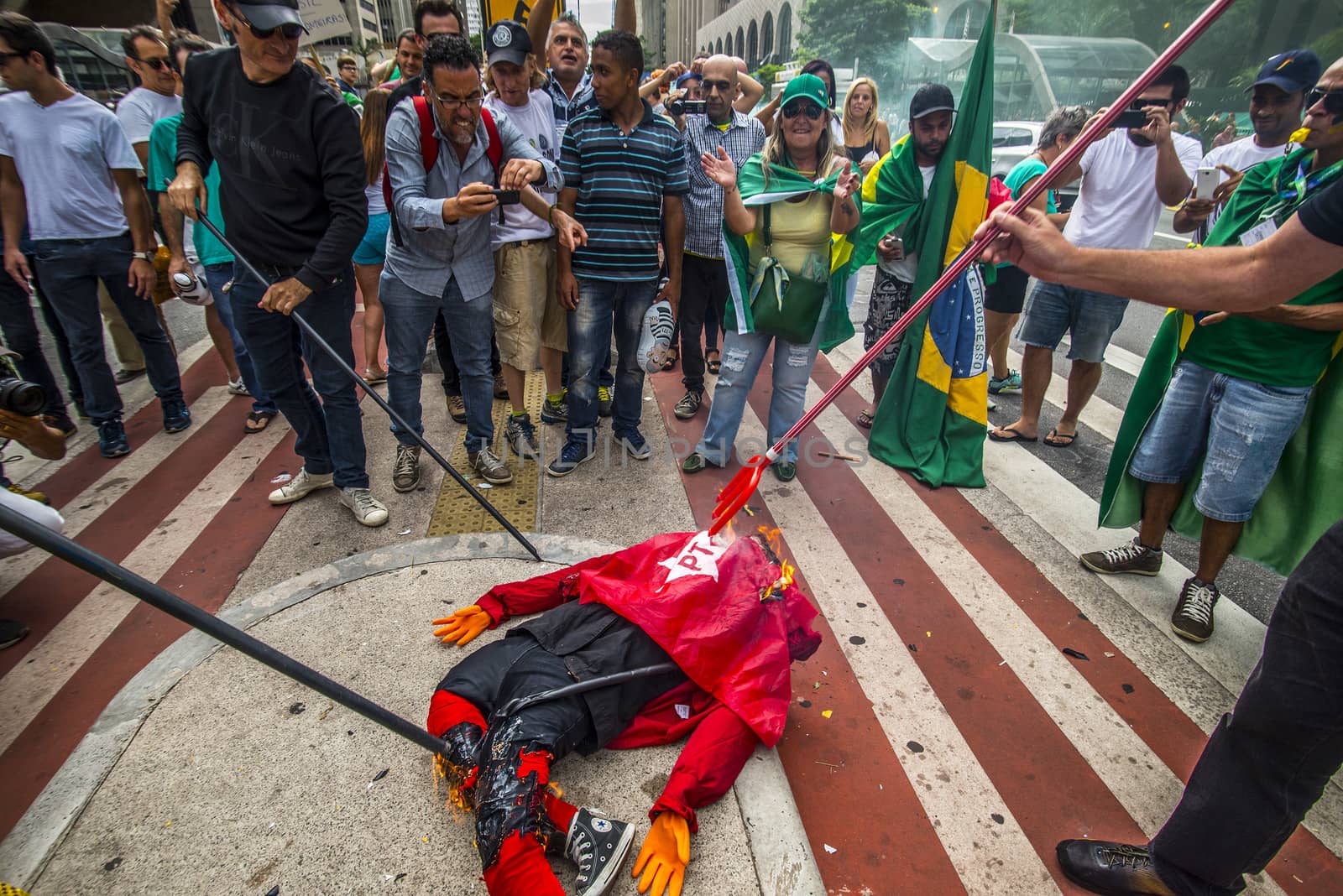 BRAZIL, Sao Paulo: Demonstrators destroy symbols of ruling party,  Workers' Party (PT) during a protest for the impeachment of President Dilma Rousseff, against former president Lula and against corruption in Petrobras scandal case in Sao Paulo, Brazil on March 26, 2016. Brazilian lawmakers relaunched impeachment proceedings against President Dilma Rousseff Thursday and a judge blocked her bid to bring her powerful predecessor into her cabinet, intensifying the political crisis engulfing her. 