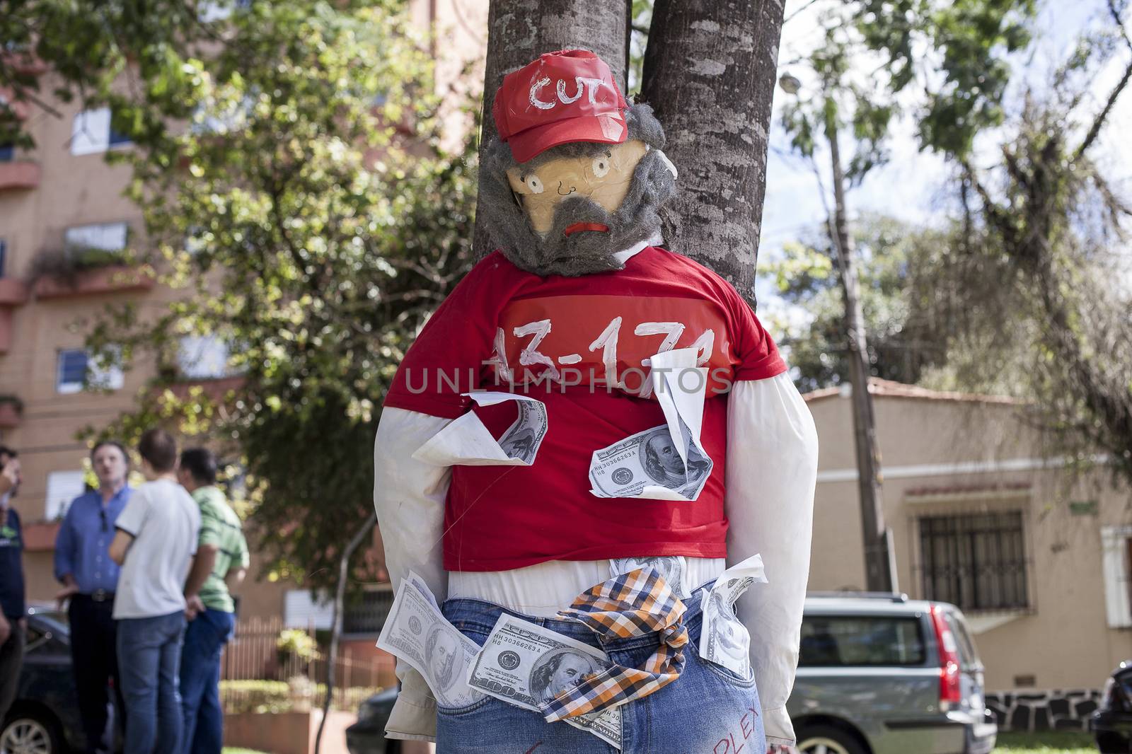 BRAZIL, Curitiba: A picture is taken of an effigie of Brazilian former president (2003-2011) Luiz Inacio Lula da Silva known as Lula as protesters beat effigies of President Dilma Rousseff and former President Lula in front of the Federal Court in Curitiba, Brazil on March 26, 2016. Traditionally on the Saturday before Easter, Catholics beat effigies of Judas the apostle. This year protesters in favor of impeachment of the President of Brazil, used the tradition as a political demonstration.