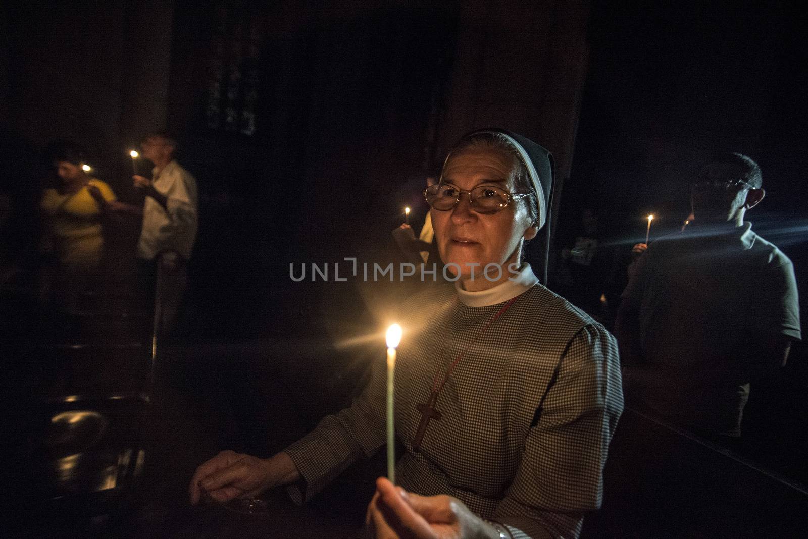 BRAZIL, Sao Paulo: Churchgoers hold candles as they attend Easter mass and vigil at São Paulo See Metropolitan Cathedral on March 26, 2016. Christians around the world are marking the Holy Week, commemorating the crucifixion of Jesus Christ, leading up to his resurrection on Easter.