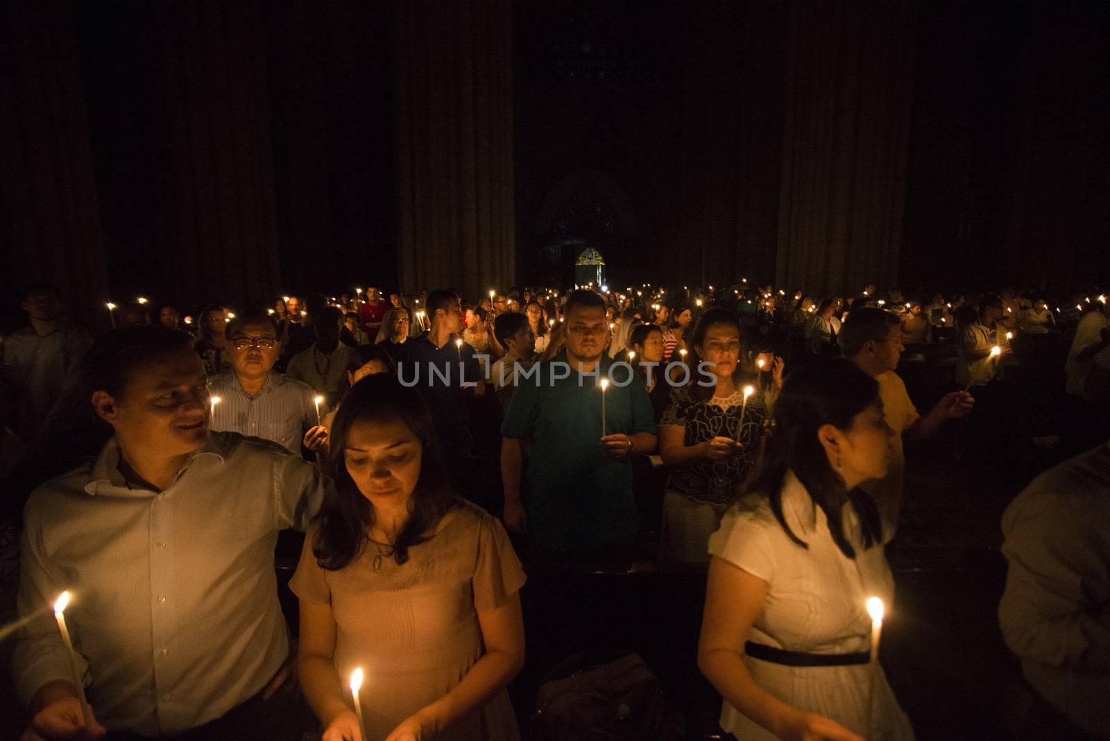 BRAZIL, Sao Paulo: Churchgoers hold candles as they attend Easter mass and vigil at São Paulo See Metropolitan Cathedral on March 26, 2016. Christians around the world are marking the Holy Week, commemorating the crucifixion of Jesus Christ, leading up to his resurrection on Easter.