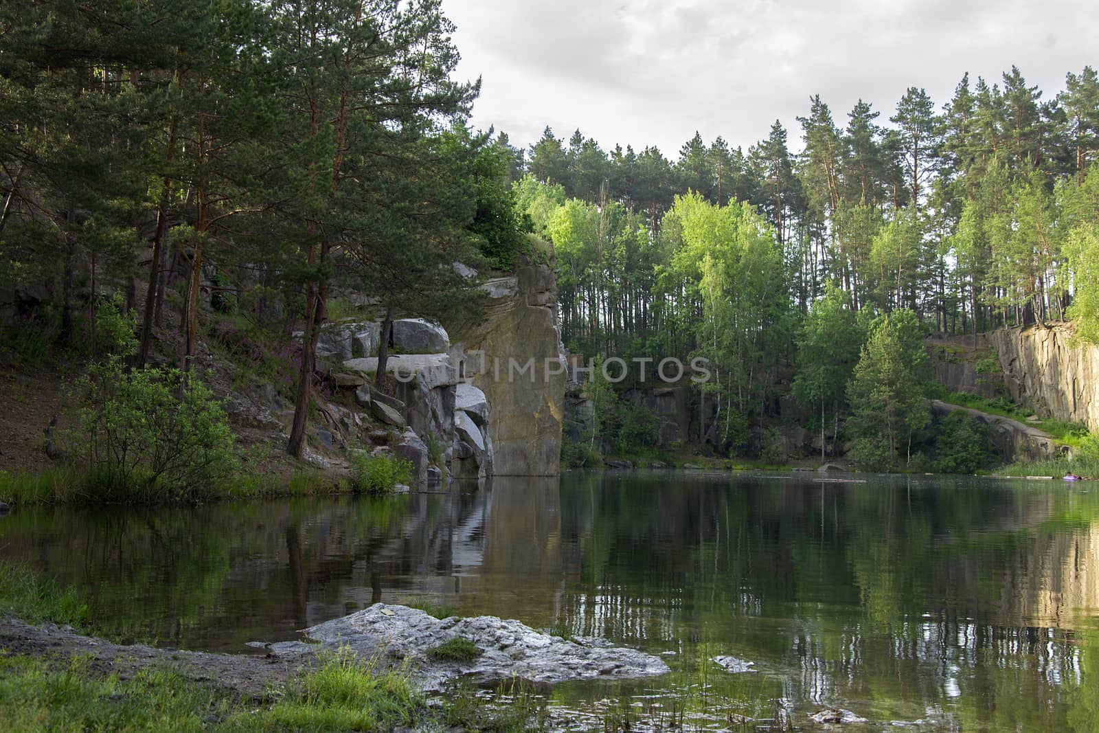 Lake in the stone canyon surrounded by forest by Irene1601