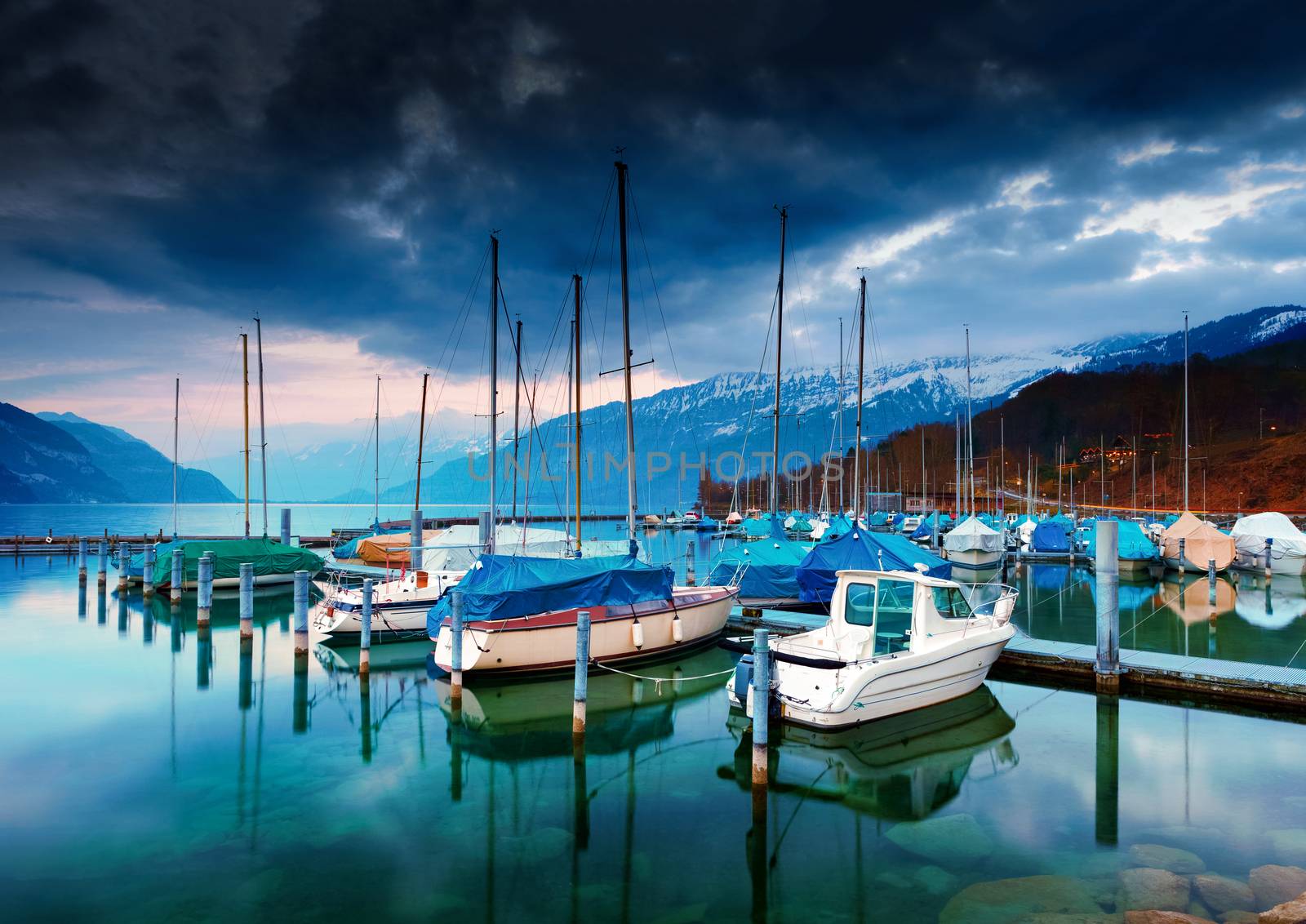 Boats and yachts on lake Thun at night. Bernese Oberland, Switzerland.