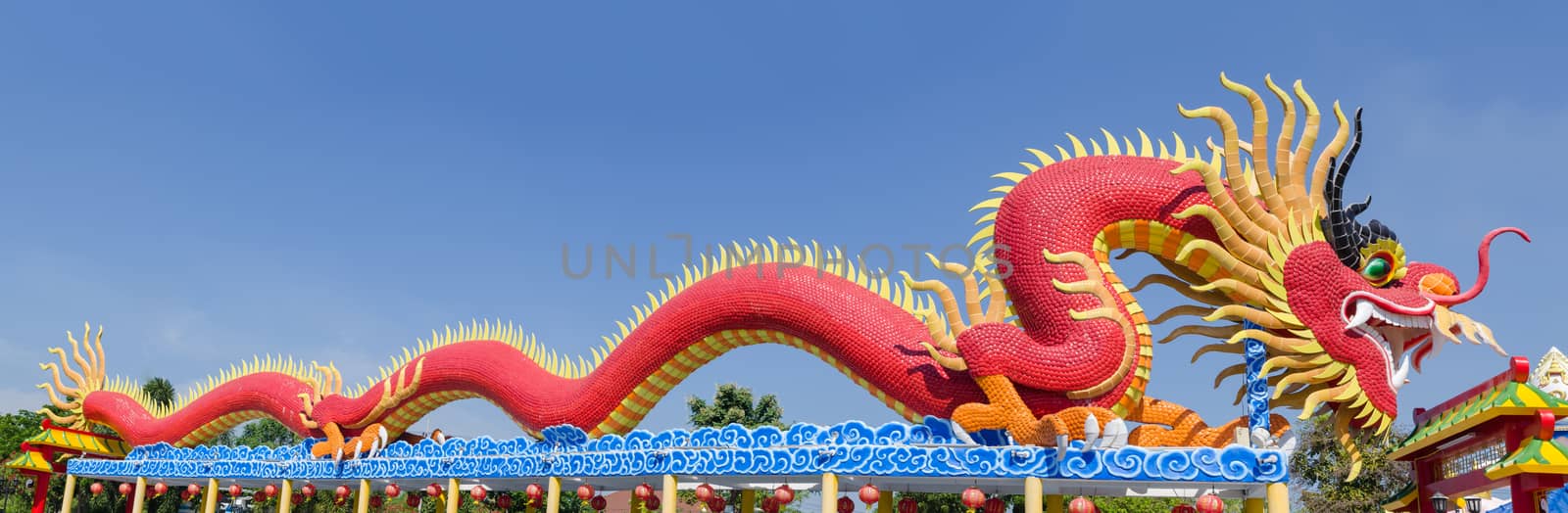 Panorama Chinese dragon in a public park image on blue backgrounds.