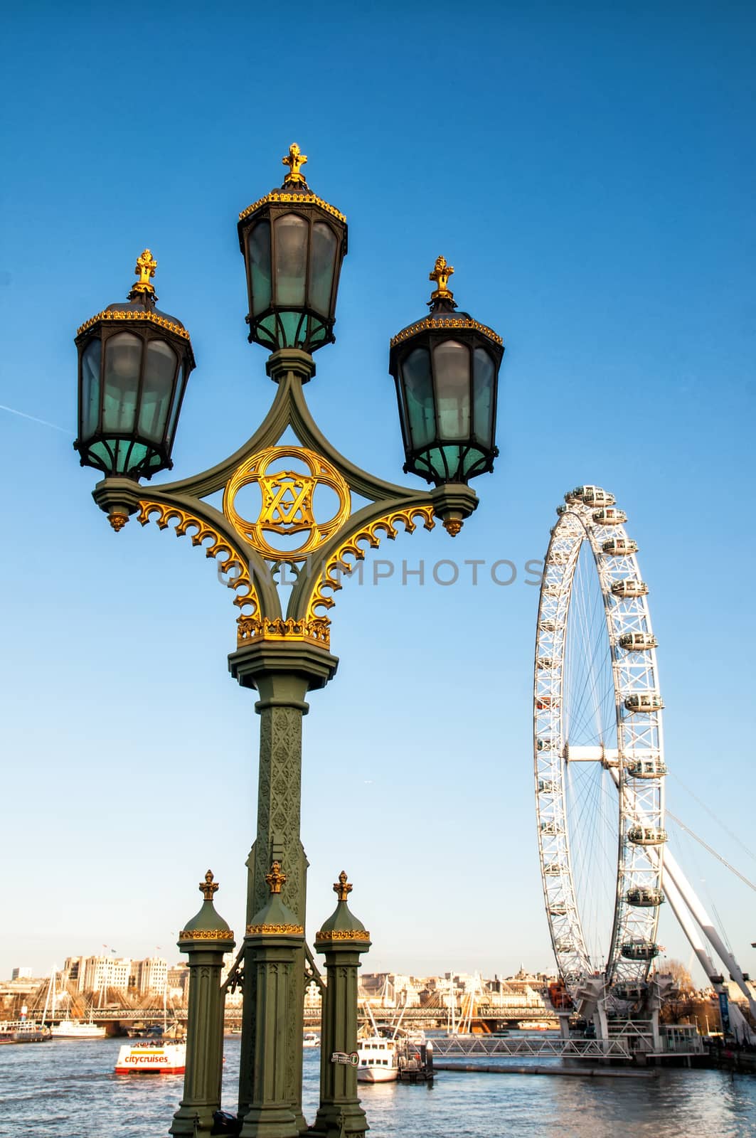 London Eye (135 m tall, diameter of 120 m) - a famous tourist attraction over river Thames