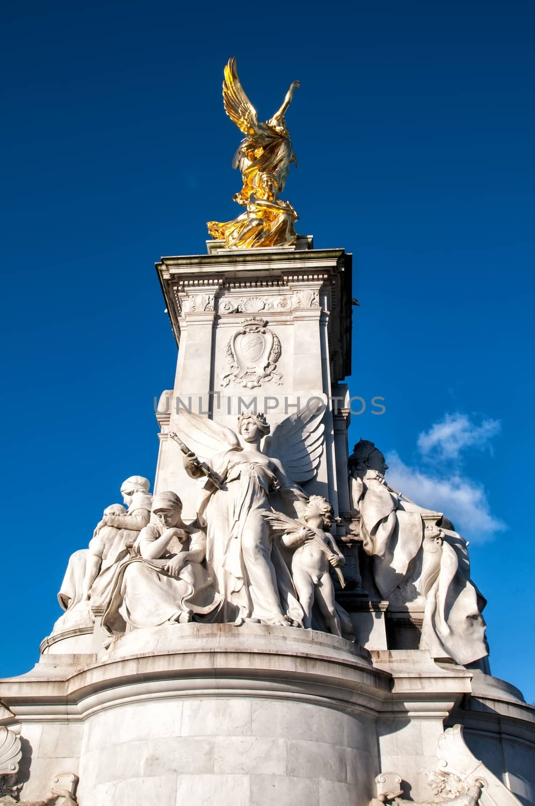 The Victoria Memorial is a sculpture dedicated to Queen Victoria, sculpted by Sir Thomas Brock in London, placed at the centre of Queen's Gardens in front of Buckingham Palace.