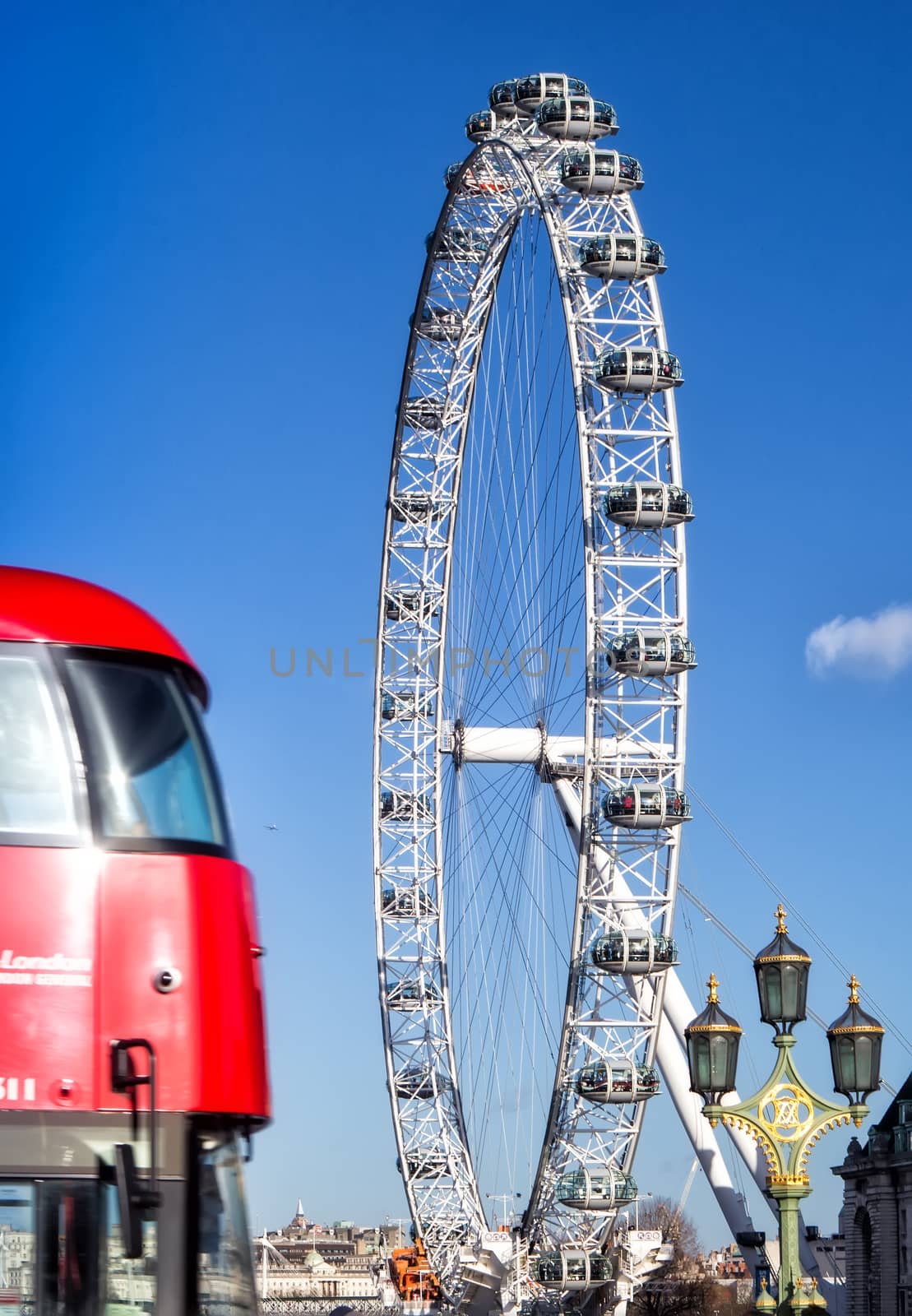 London Eye (135 m tall, diameter of 120 m), a famous tourist attraction over river Thames.
