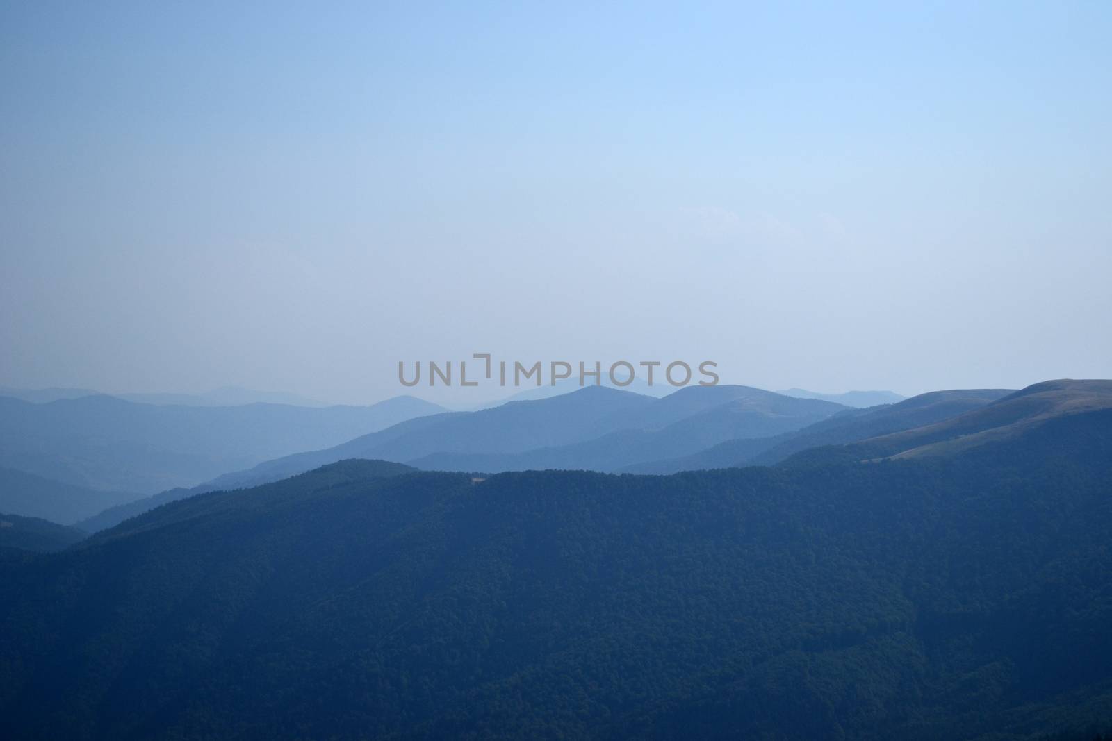 Mountain peaks in the autumn evening sky with clouds by Irene1601