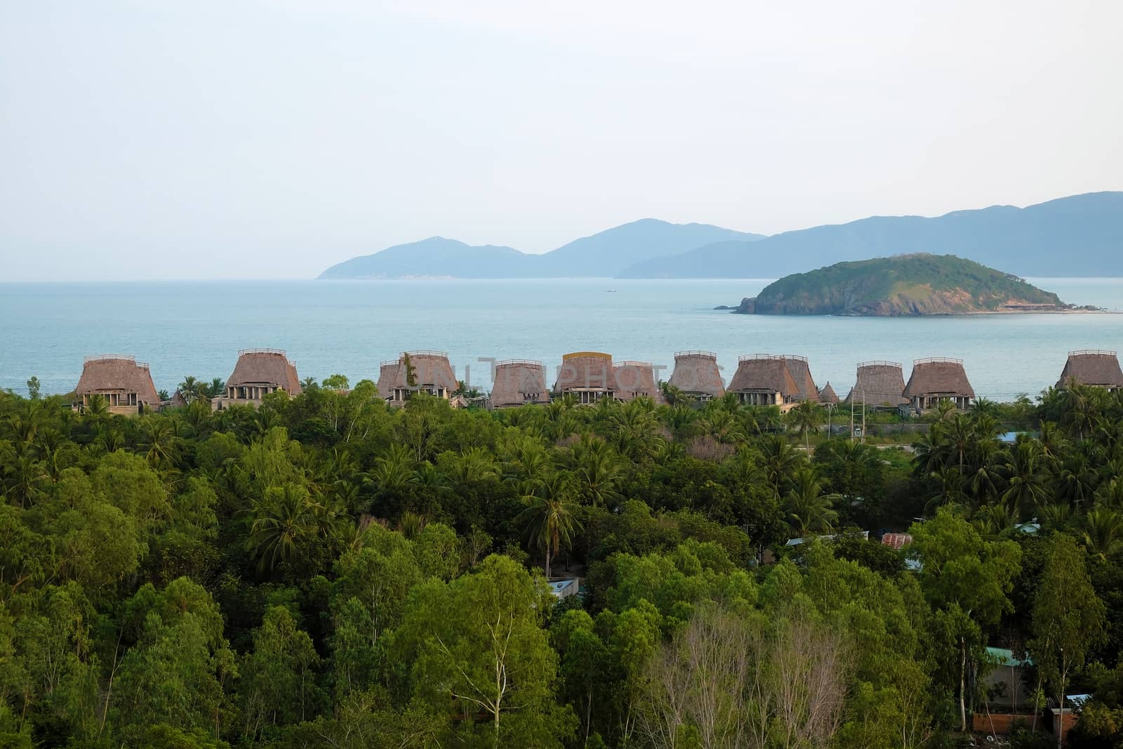 Beautiful seaside resort with group of beach bungalow, tourist area among coconut tree, sea and mountain, eco green environment, great place for holiday vacation in summer at Nha Trang, Vietnam