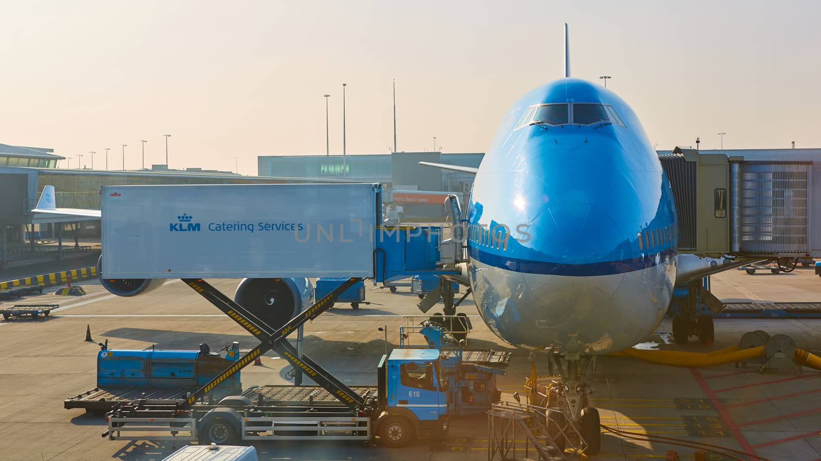 Amsterdam, Netherlands - March 11, 2016: KLM plane being loaded at Schiphol Airport