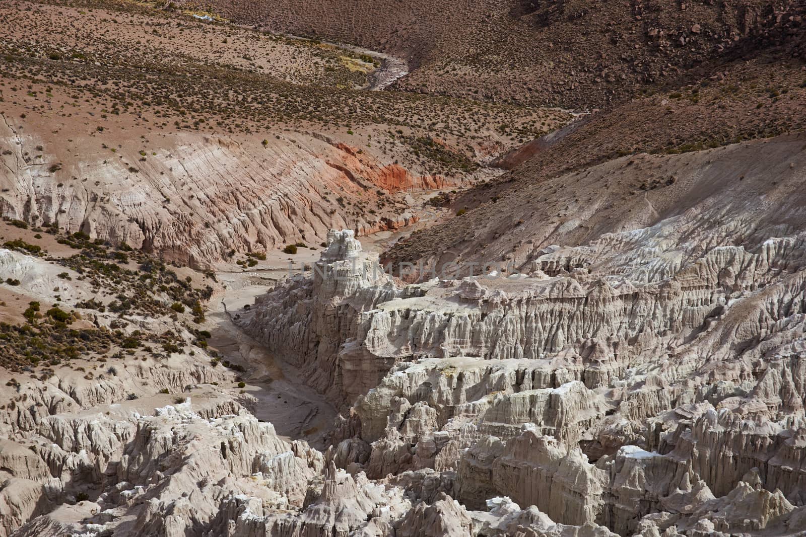 Eroded rock formations at the head of a river valley feeding the River Lauca high up on the Altiplano of northern Chile in Lauca National Park.