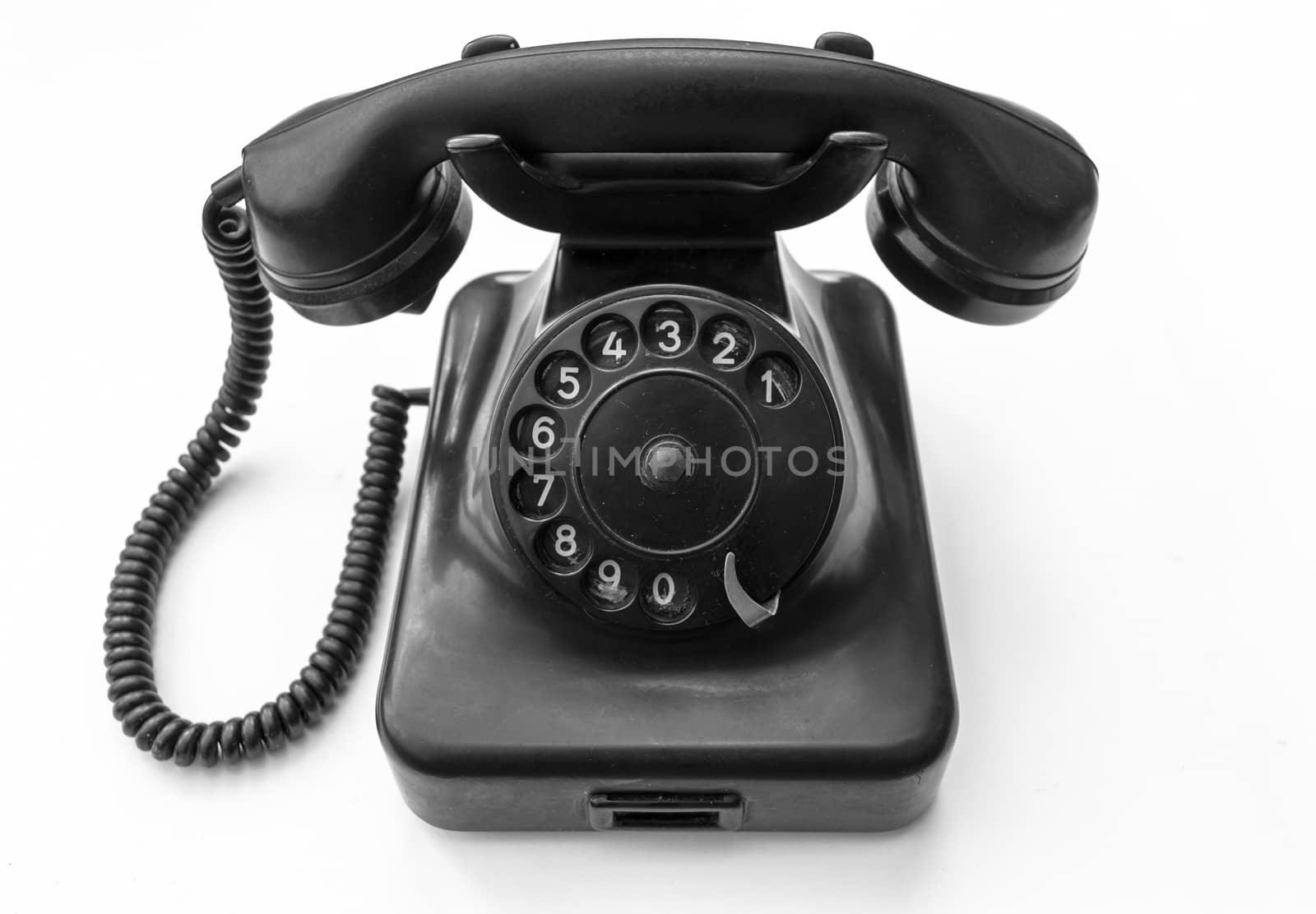 Old telephone on white background  by radzonimo