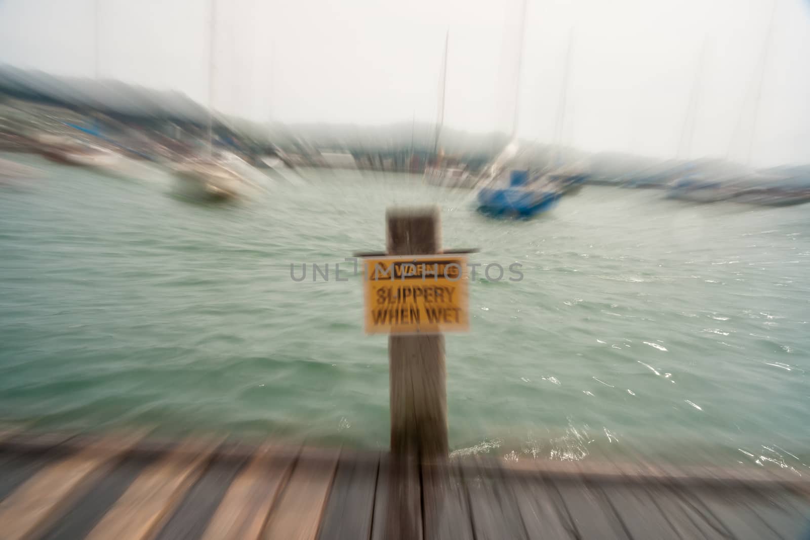 Slippery when wet sign in zoom blur effect by brians101