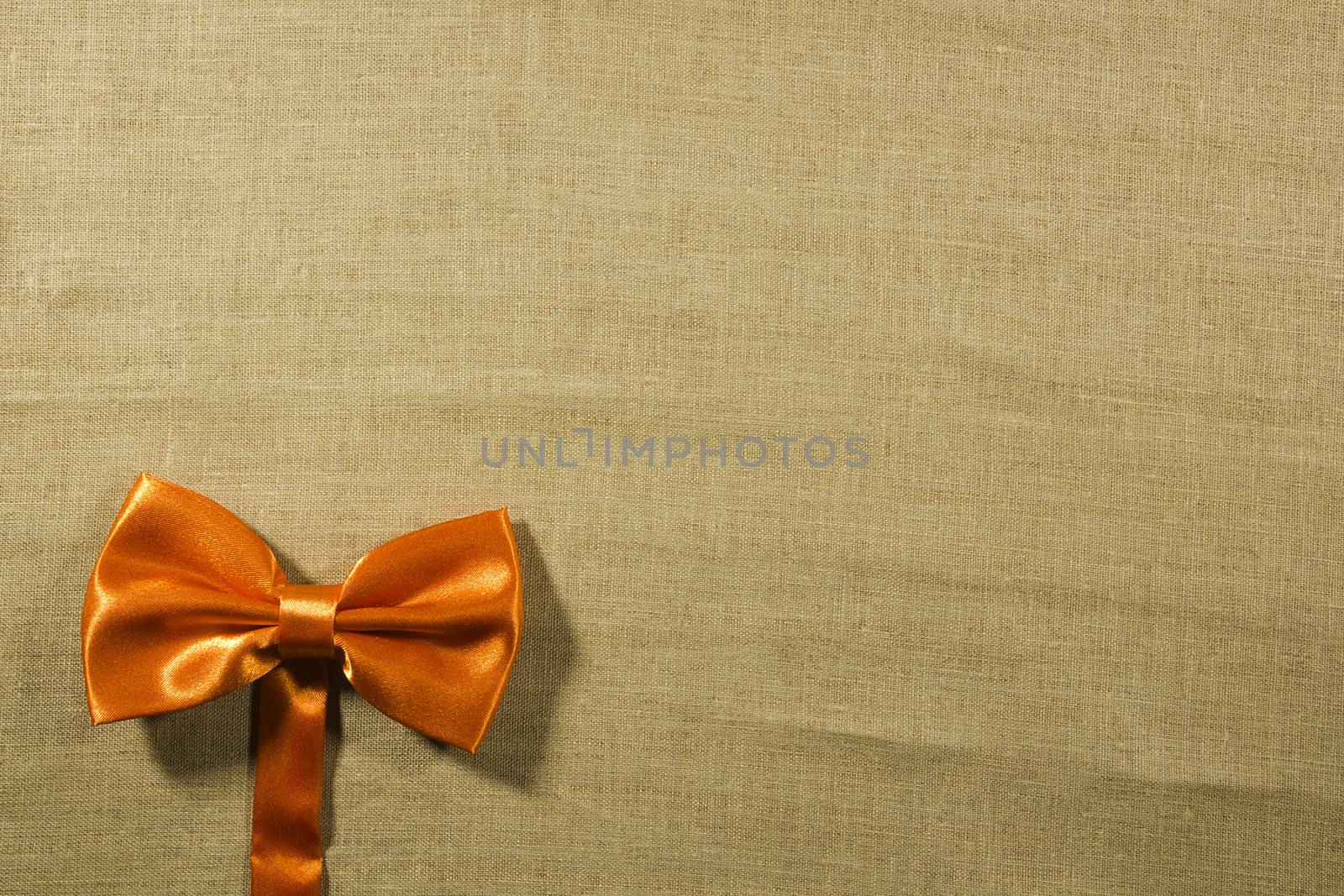 Bow tie on a background of white linen napkins