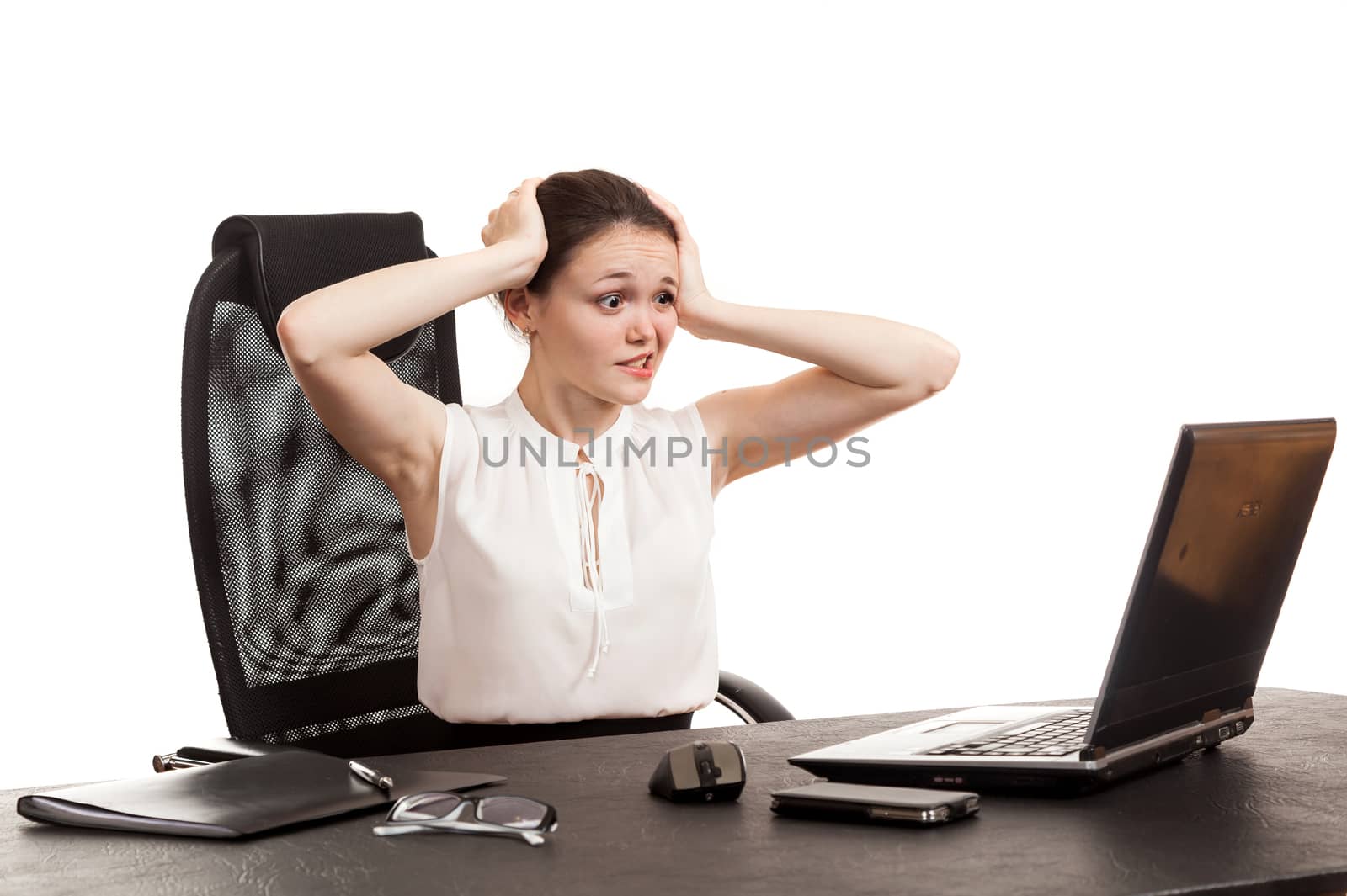 the business woman sits at office table with the laptop holding the head