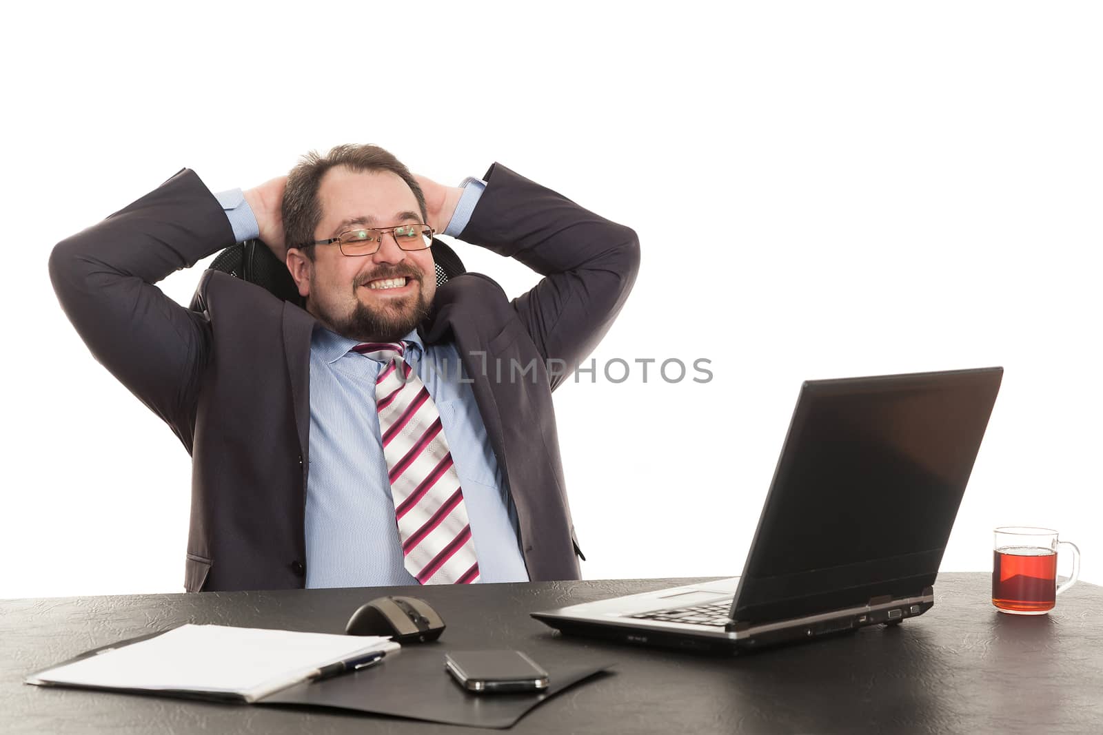 the businessman sits at office table with the laptop