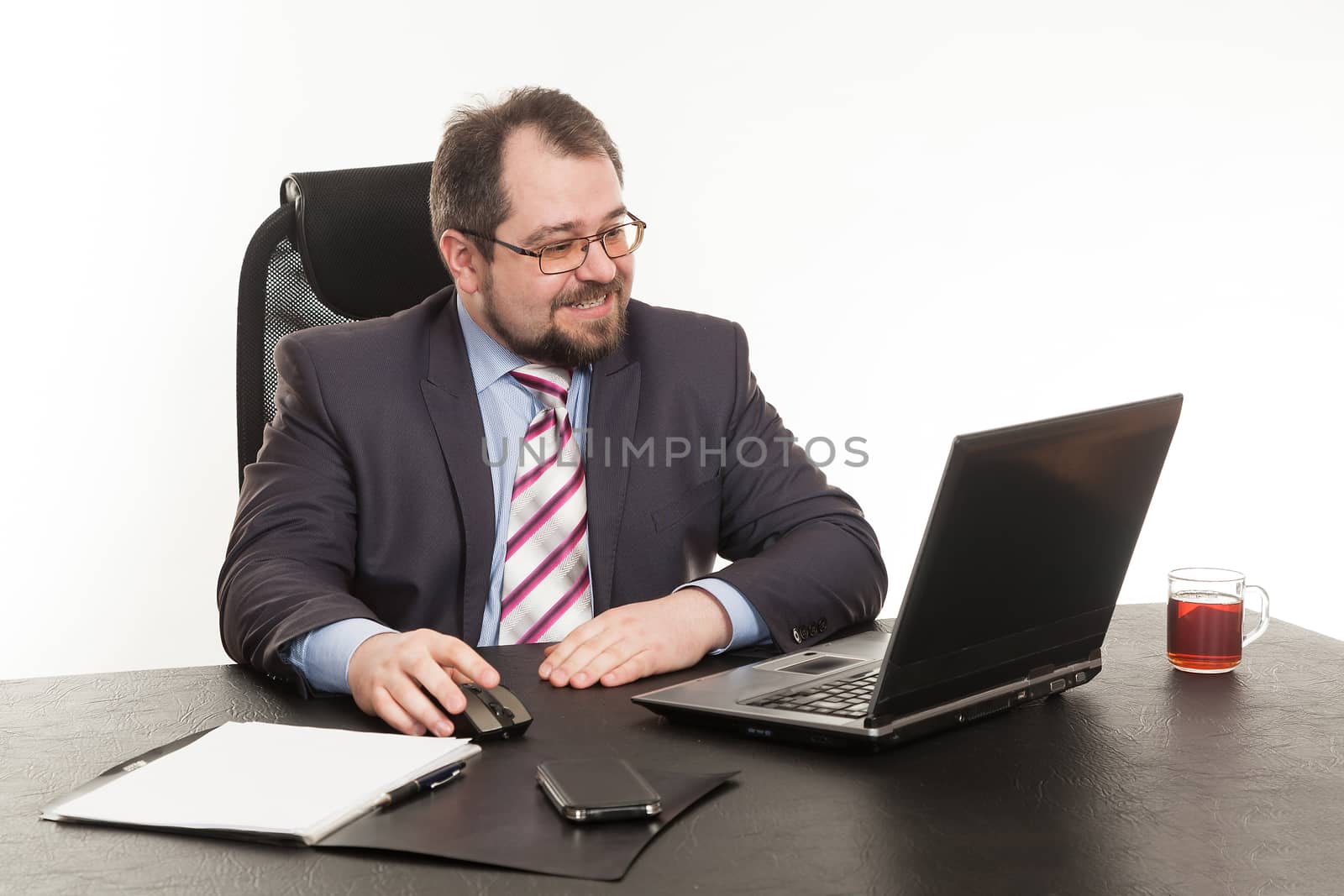 the businessman sits at office table by sveter