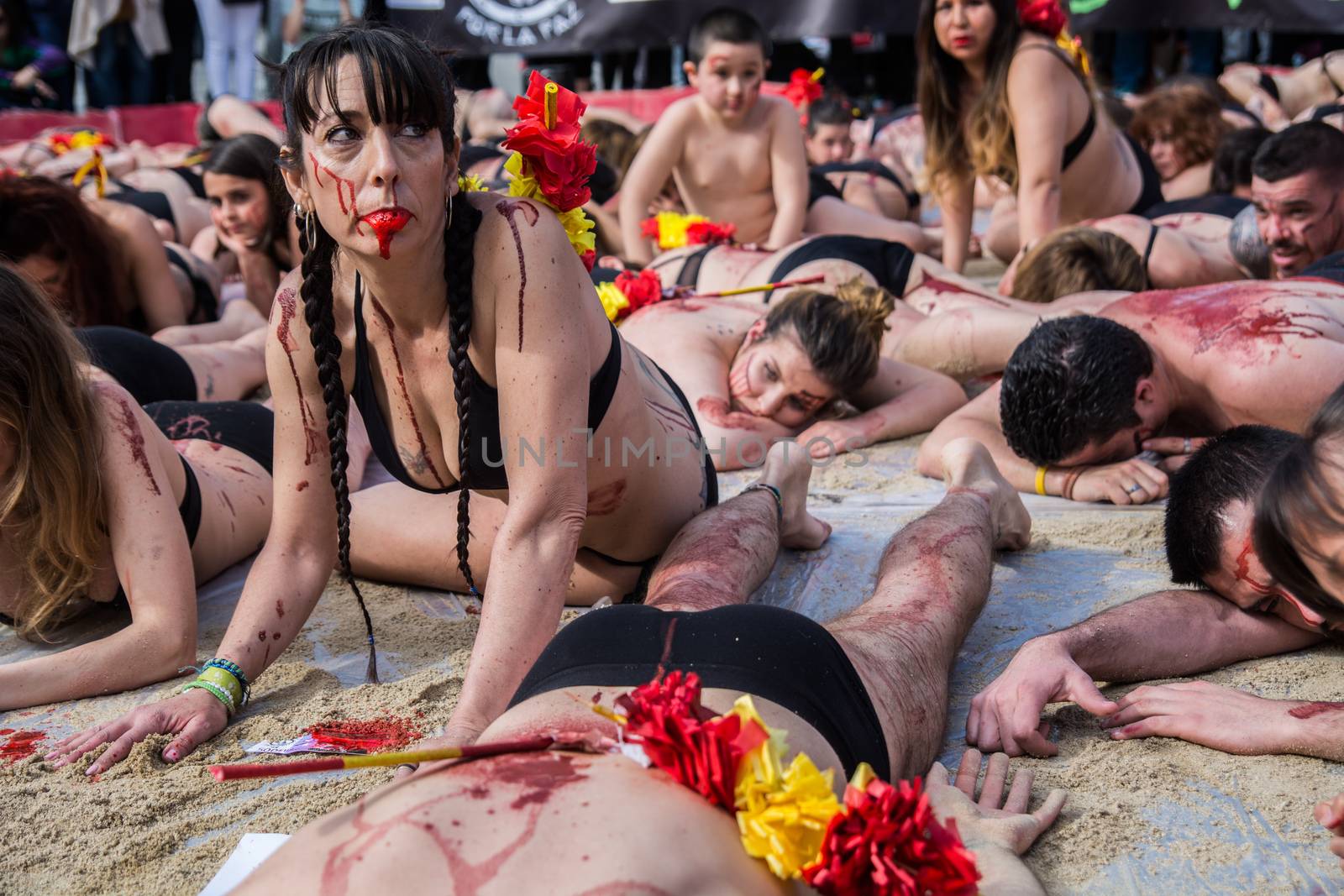 SPAIN, Madrid: Anti-bullfighting protesters covered with red paint as if it is blood gather at Puerta del Sol square, in Madrid, on March 27, 2016 against bullfights. They have turned the iconic square of Puerta del Sol into a bullring. Protesters demand the abolition of bullfights under the slogan  The bull suffers!