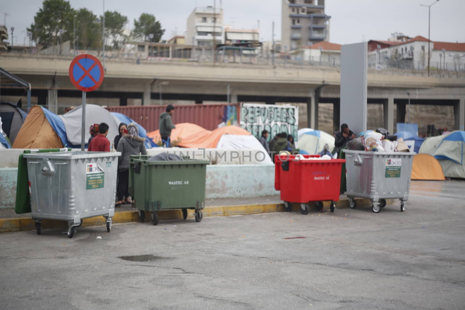 GREECE, Athens: Refugees continue to camp out under the rain, as thousands are still stranded at the Port of Piraeus in Athens, Greece on March 27, 2016. A deal between the European Union and Turkey has aimed to curb the influx of refugees to Greece, saying reception centers have become detention facilities. 