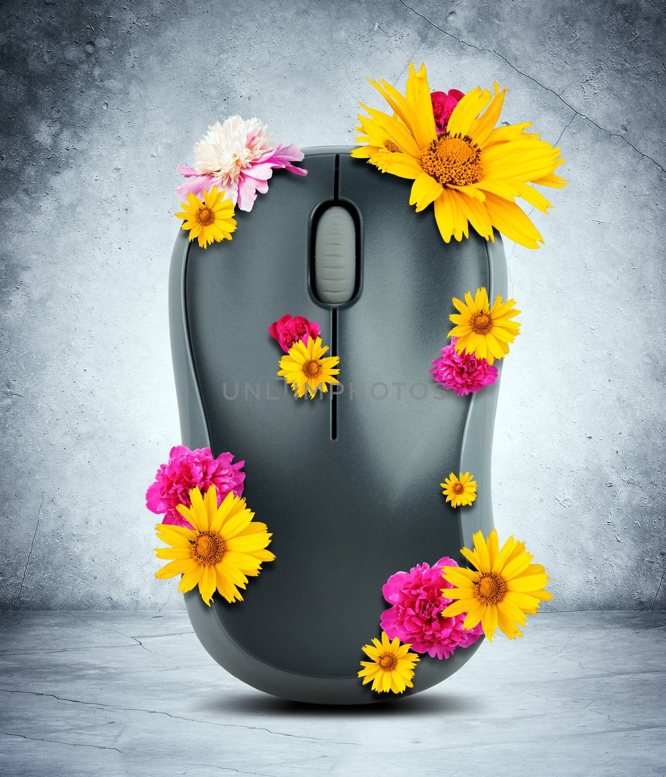 Computer mouse with flowers on grey wall background