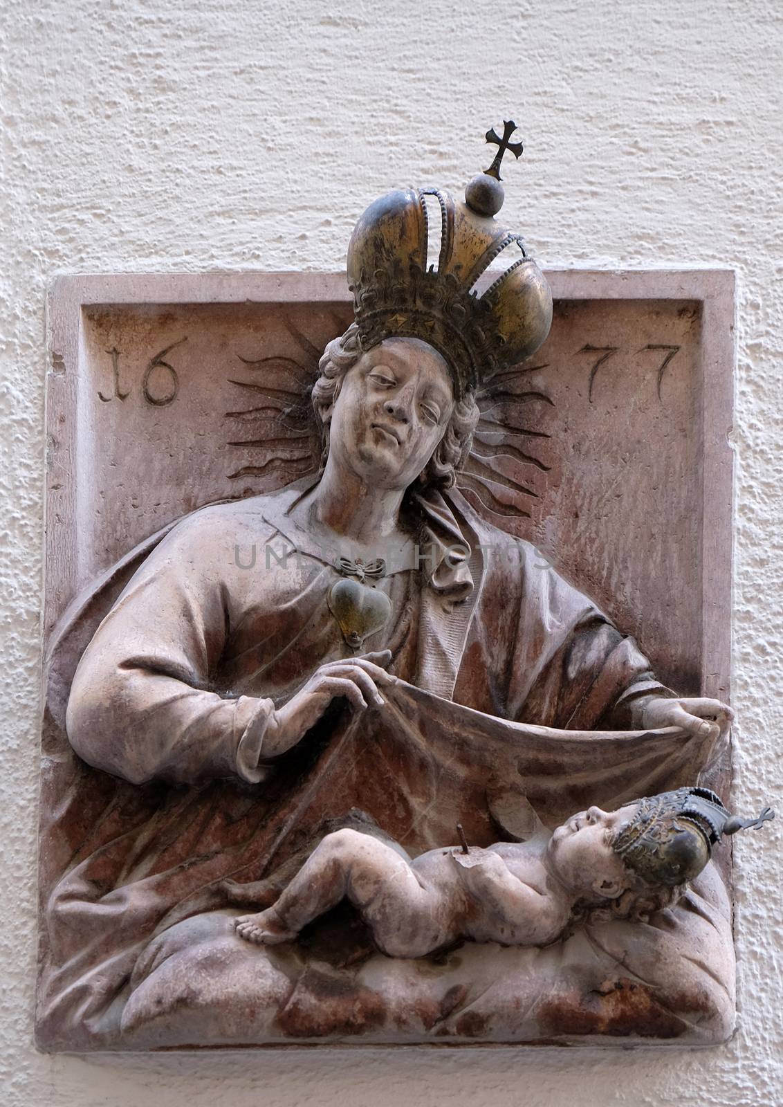 Virgin Mary with baby Jesus, statue on house facade Salzburg, Austria