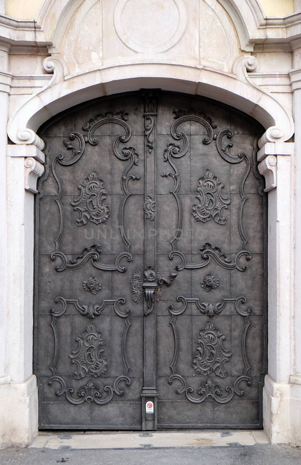 Majestic medieval door with ornate metal pattern and stone columns in Salzburg