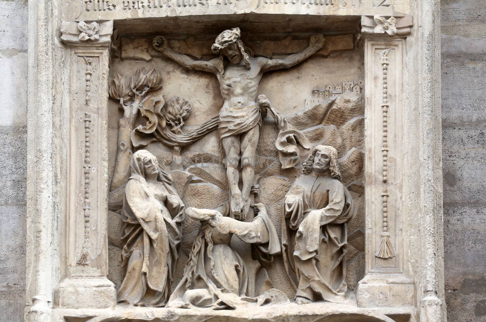 An old crucifixion relief sculpture outside St. Stephen's Cathedral in Vienna, Austria