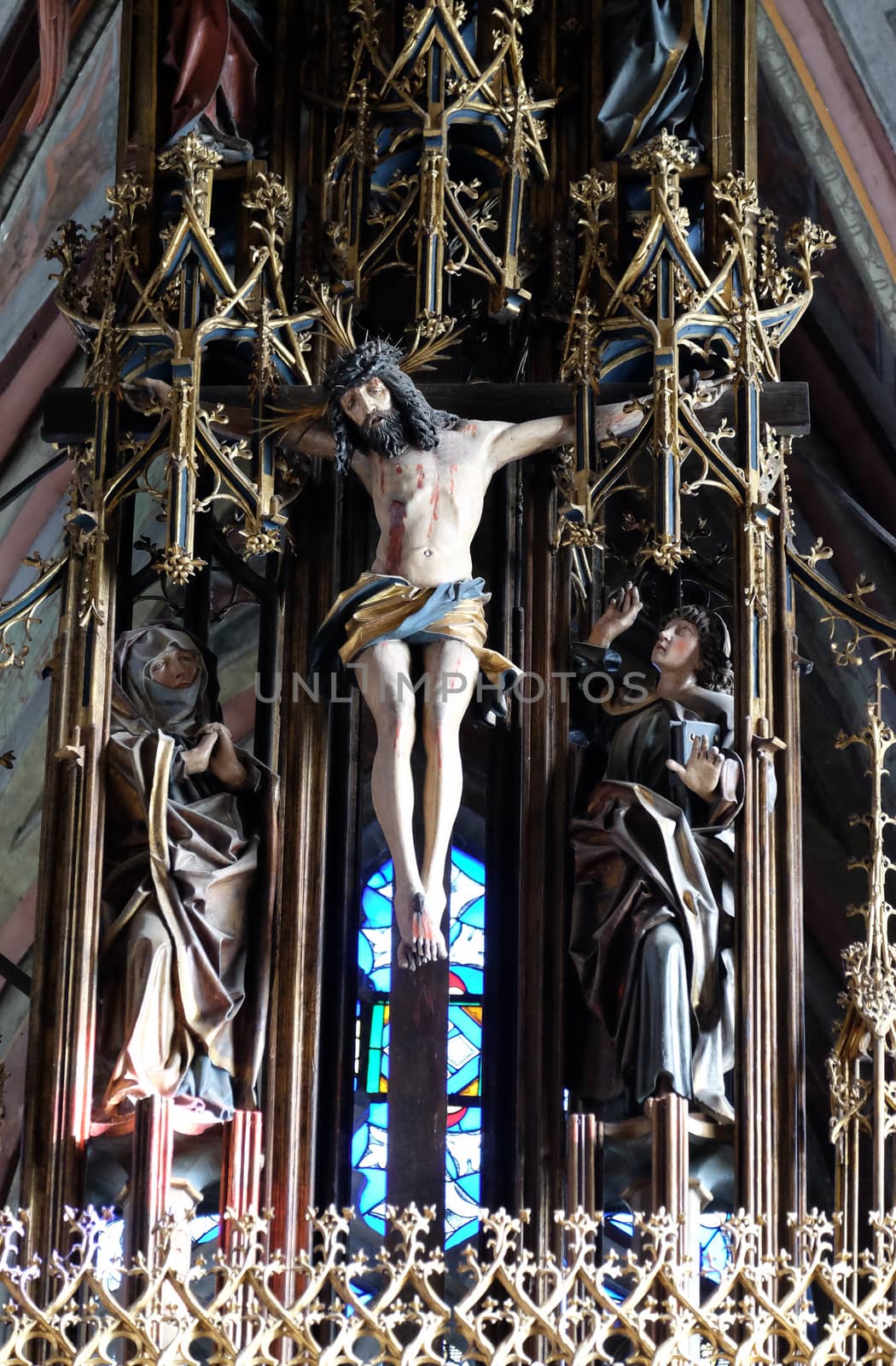 Crucifixion, Virgin Mary and St. John under the cross, main altar in Parish church in St. Wolfgang on Wolfgangsee in Austria