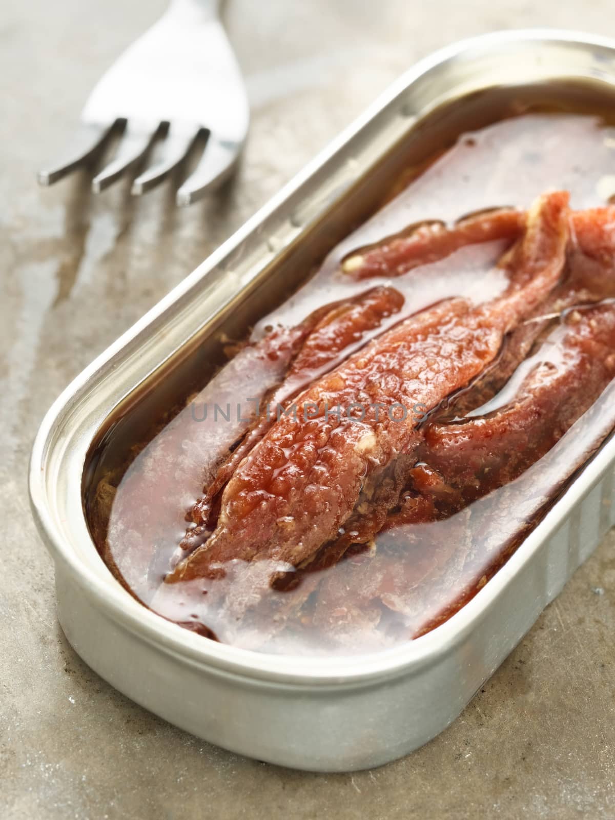close up of canned salted anchovy fillet in oil