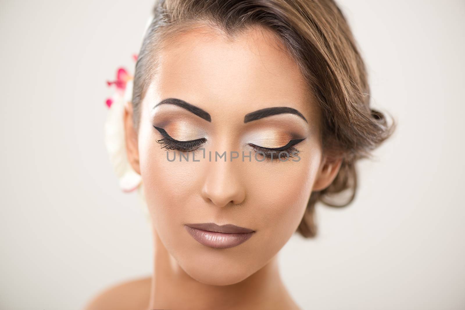 Portrait of a cute woman with nice make up posing in a studio. 