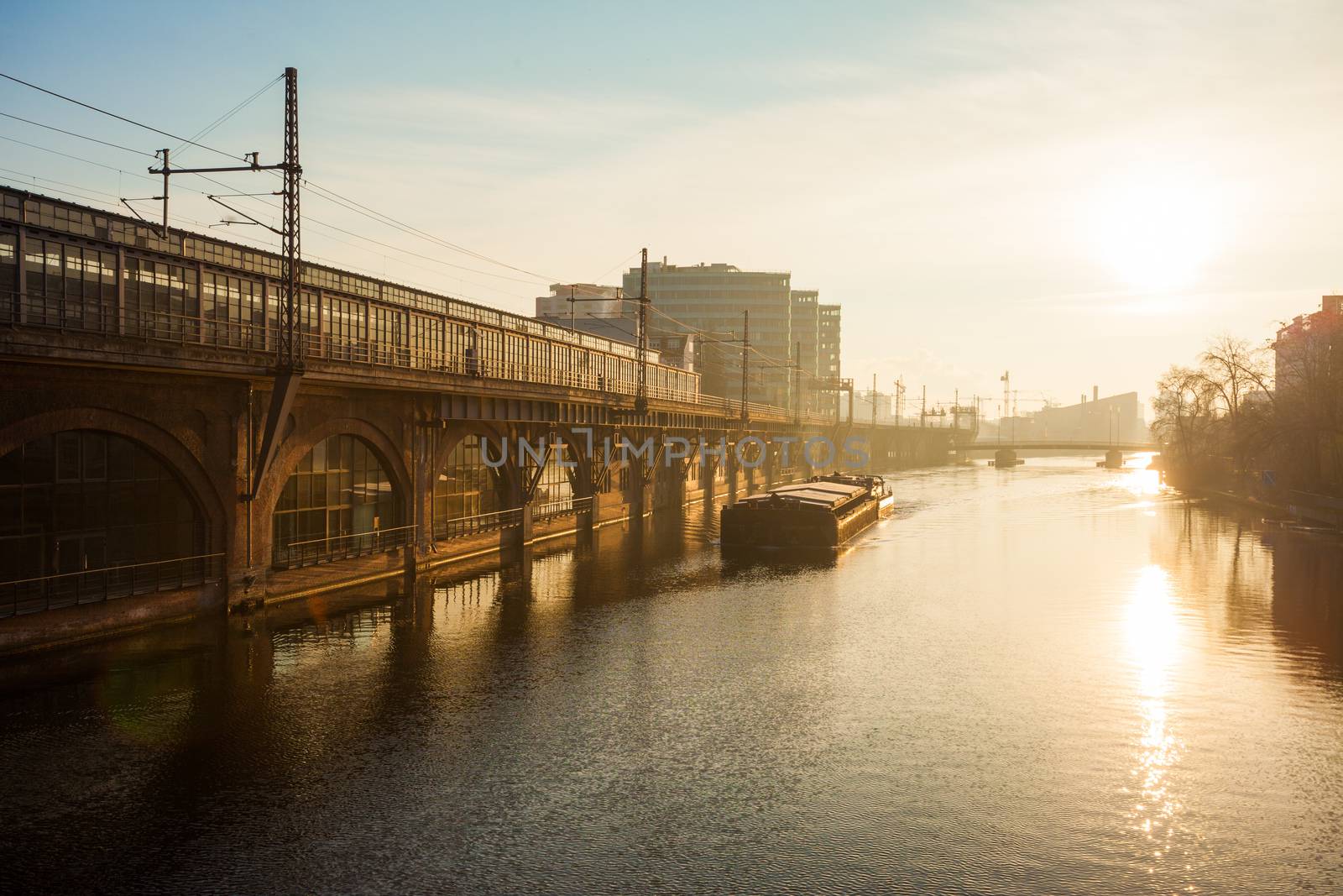 Berlin's River Spree with barge and bright sun